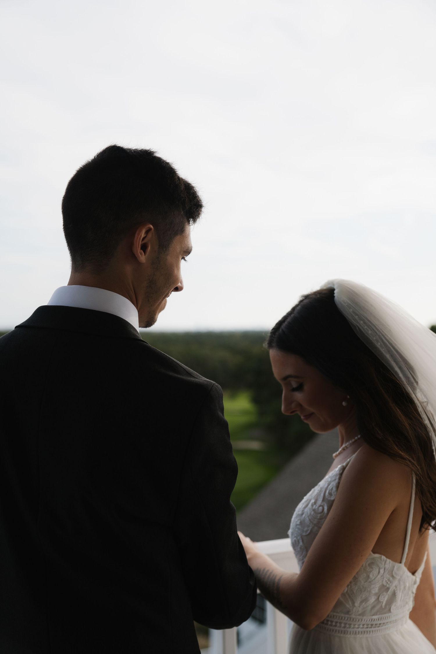 A romantic silhouette series of a bride and groom sharing intimate moments against a soft background.