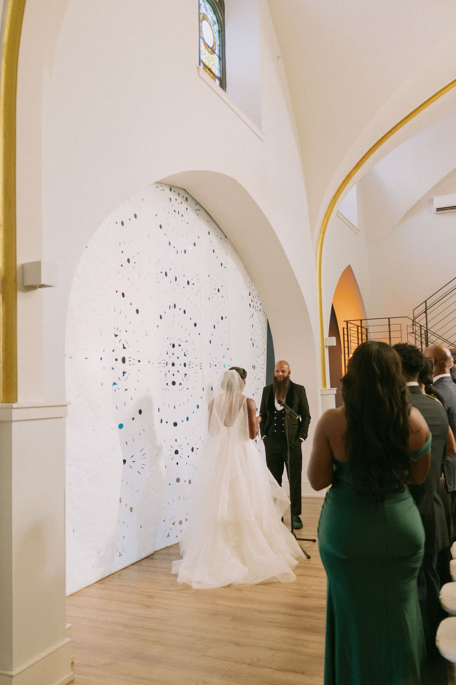 Modern gallery wedding venue with arched ceilings and artistic wall installations.