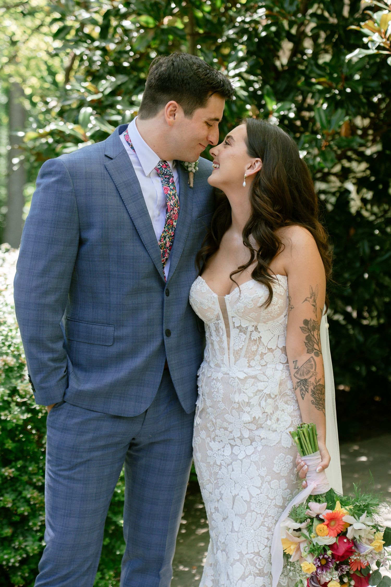 Romantic wedding portraits of a couple sharing intimate moments in a garden setting.