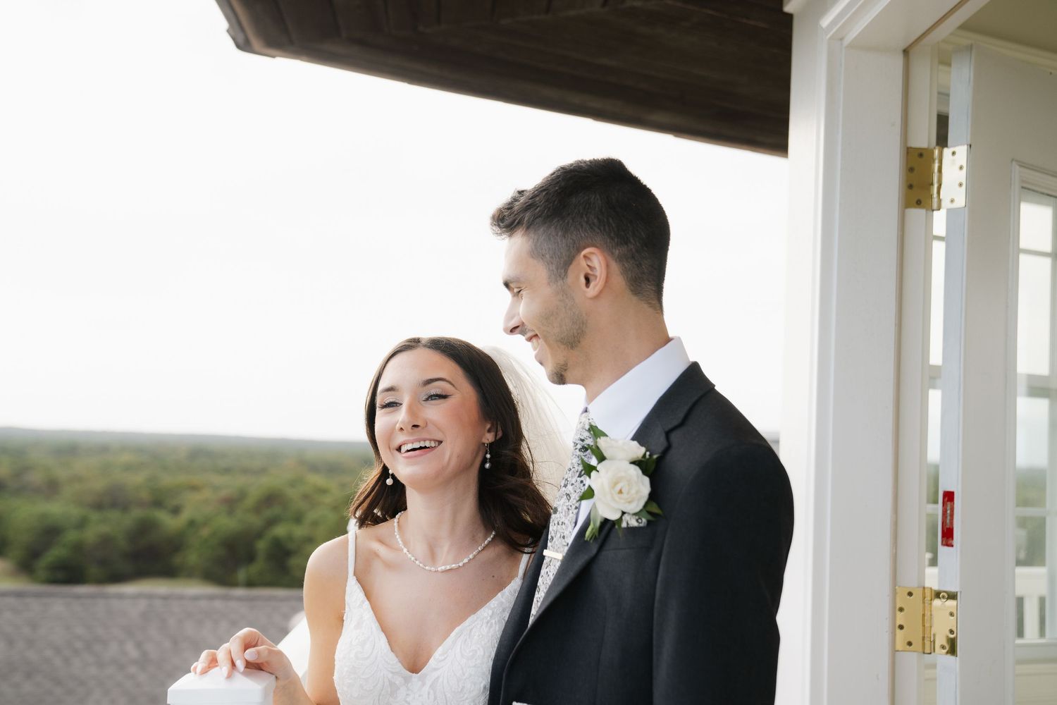 A happy couple shares a joyful moment together on their wedding day at an elegant venue.