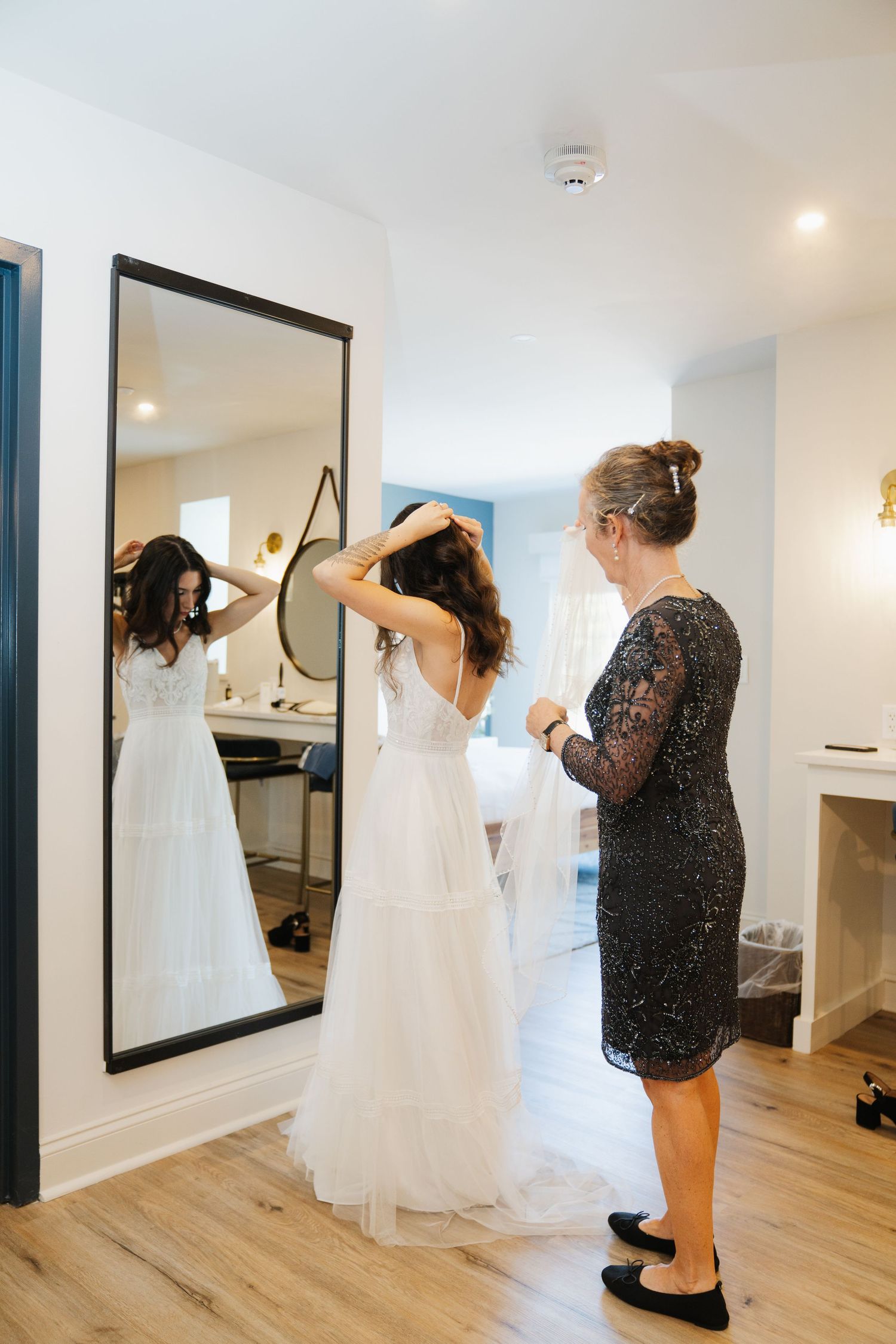 A sequence of photos showing someone trying on wedding dresses in a bridal boutique with white walls and wood floors.