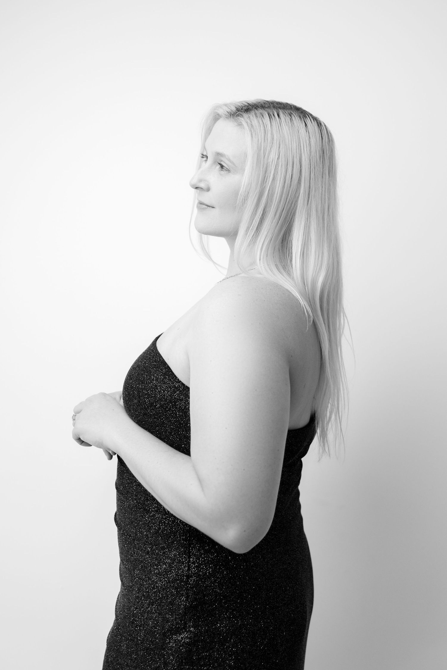 Minimalist black and white portrait series with dramatic lighting and poses.