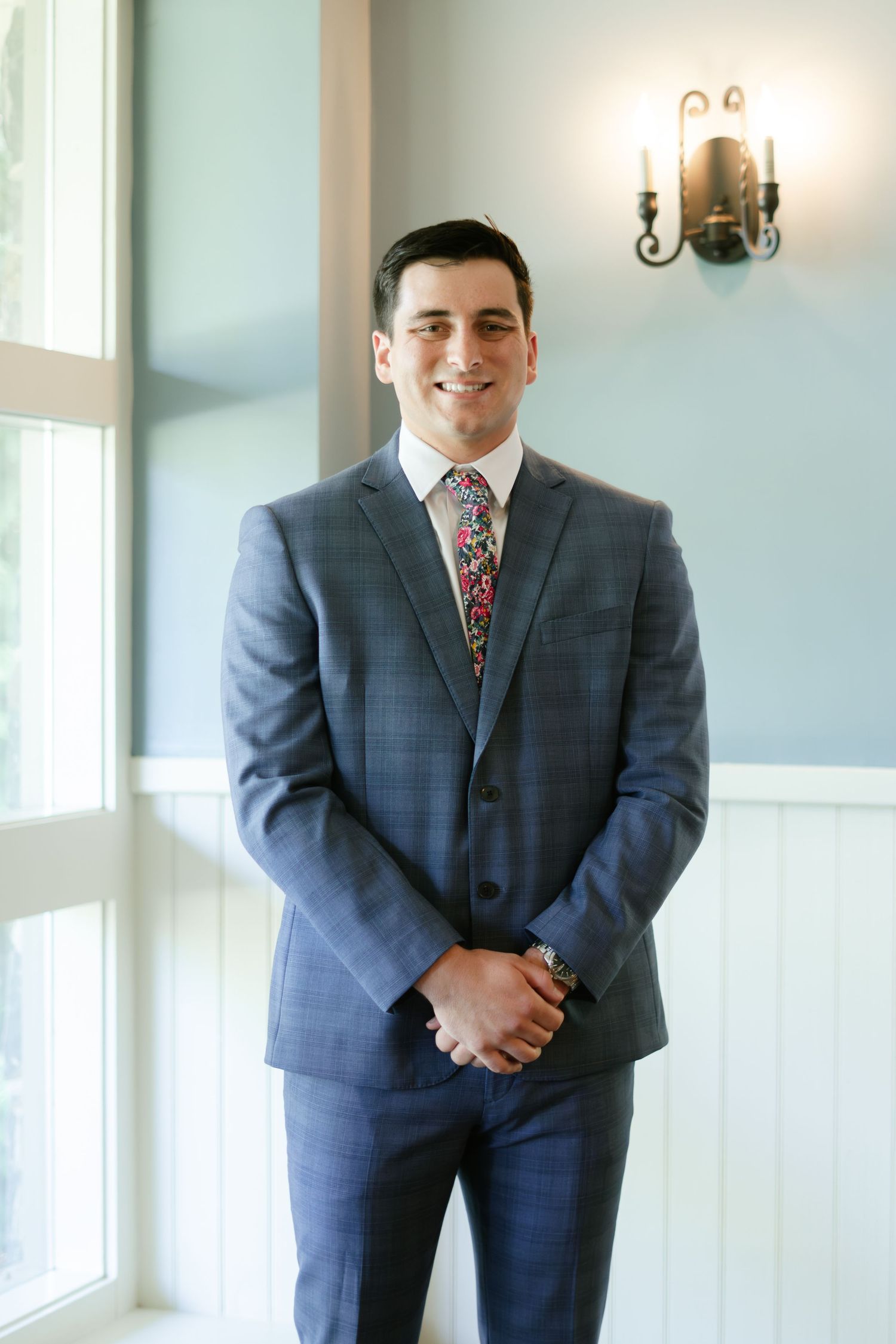 A sequence showing a person in a blue plaid suit posing in an elegant interior setting.