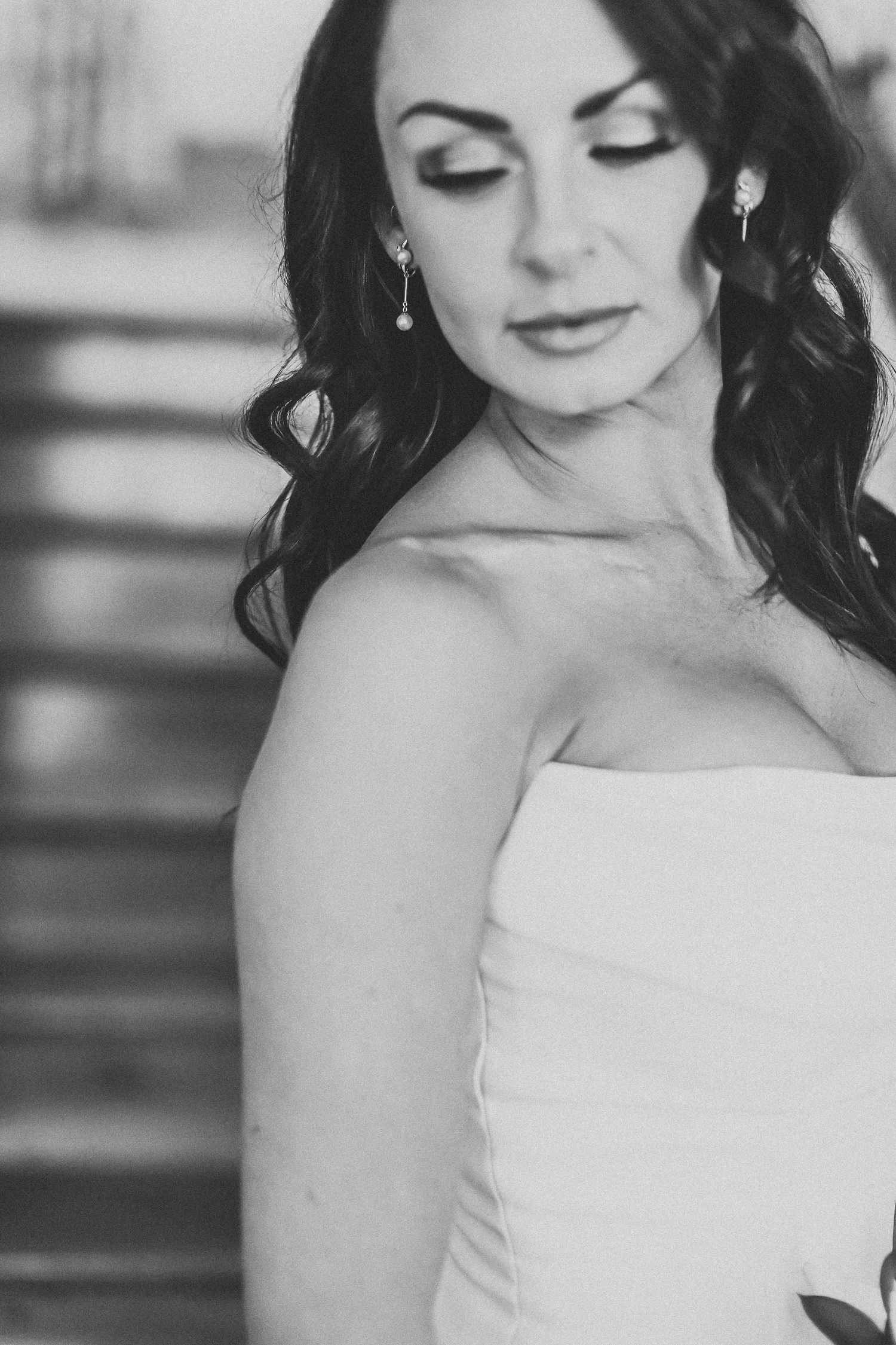 Black-and-white bridal portrait with the bride looking over her shoulder.