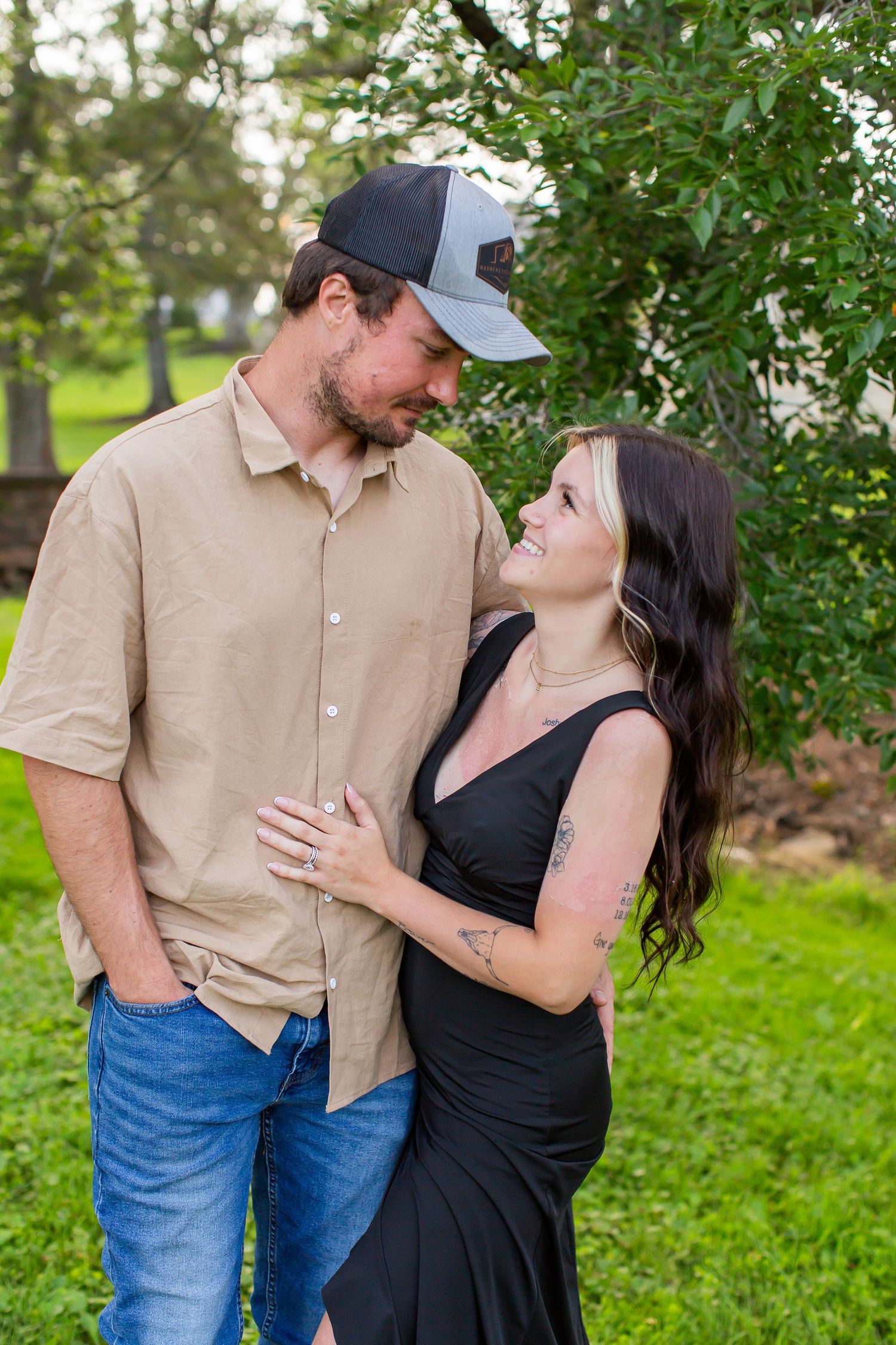 Couple smiling at each other during an outdoor portrait session.