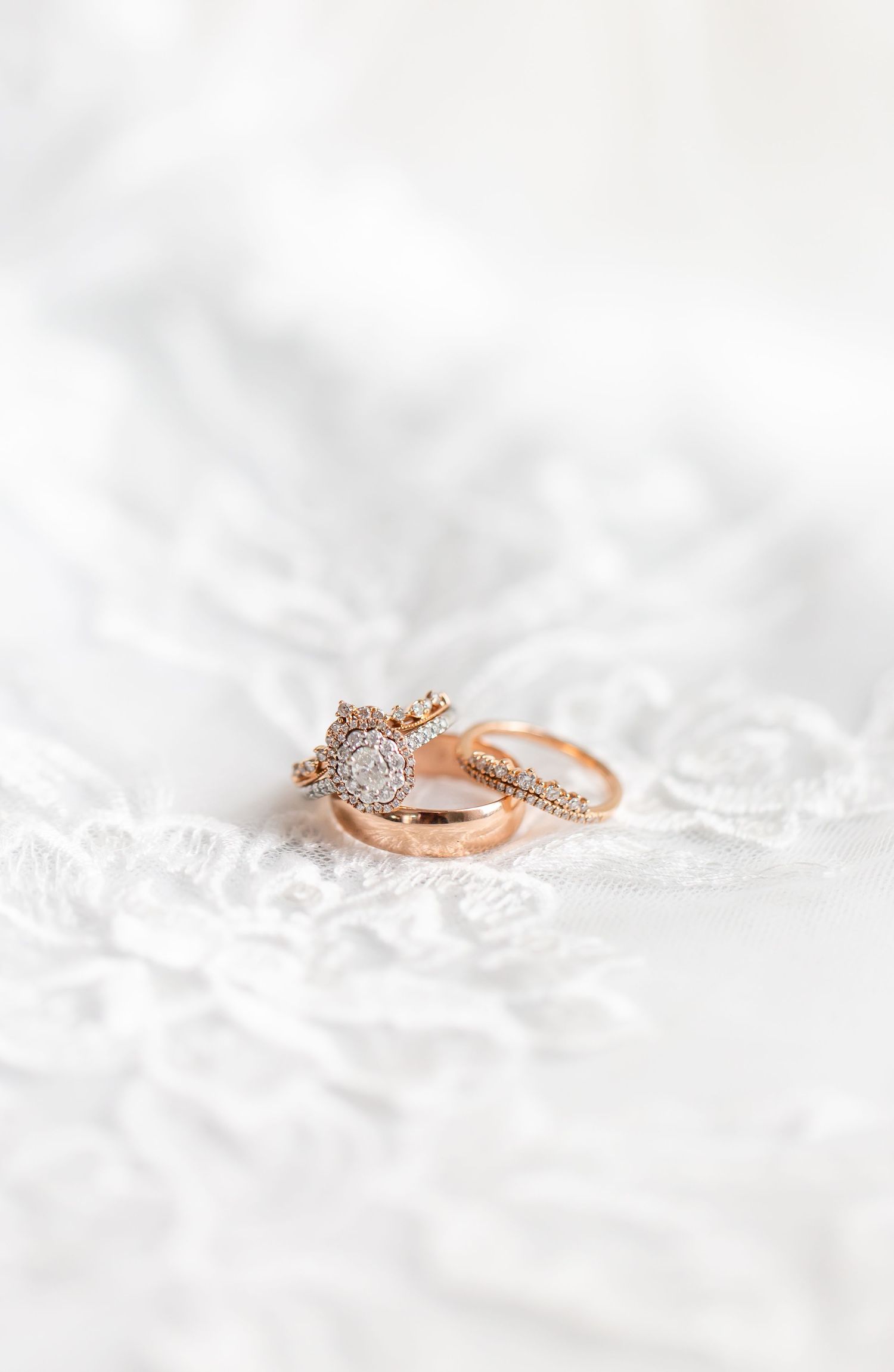 Wedding rings resting on delicate white lace.