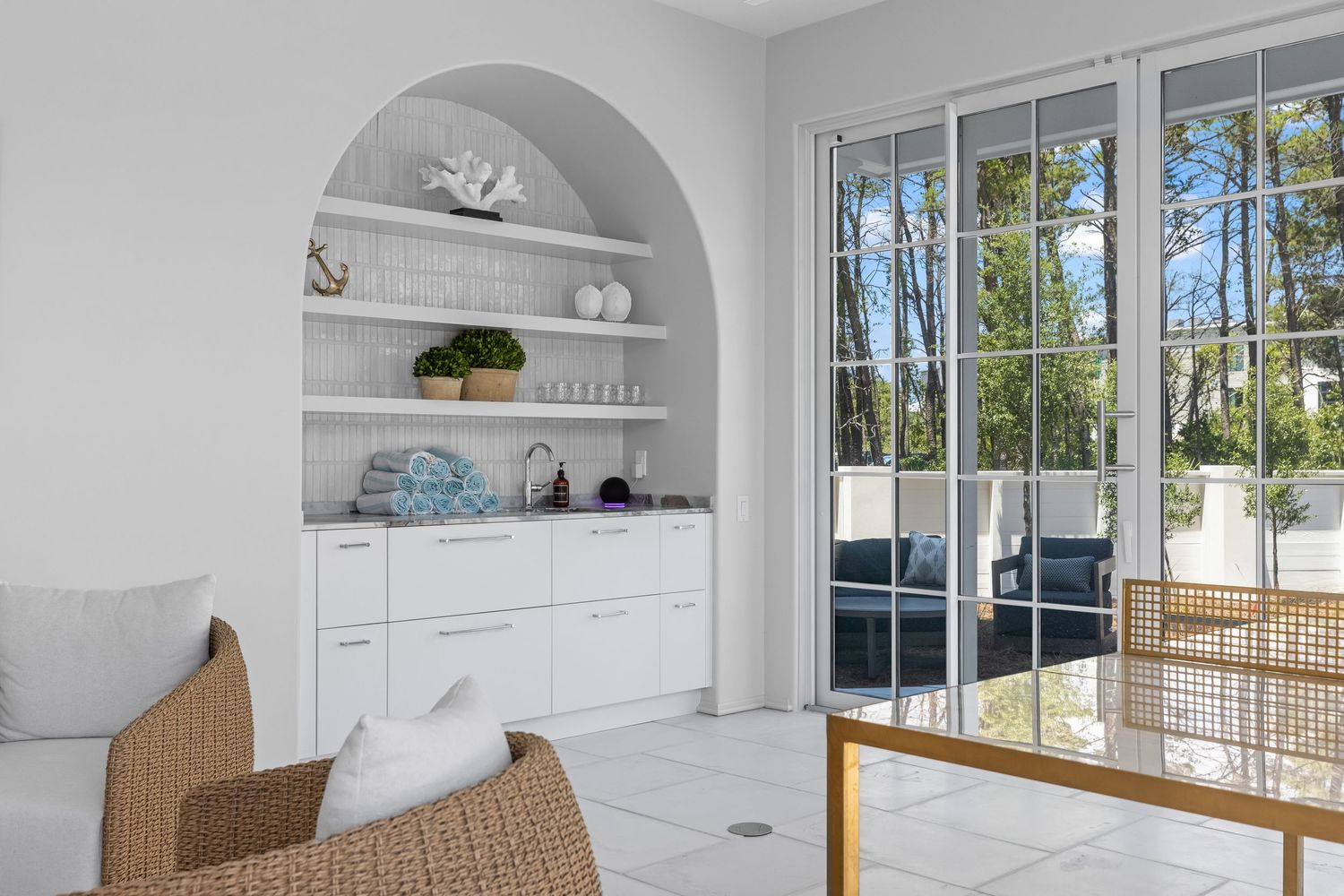 Bright sunroom with built-in shelving and natural light, photographed by Coast Captured for luxury home listings on Florida’s Emerald Coast