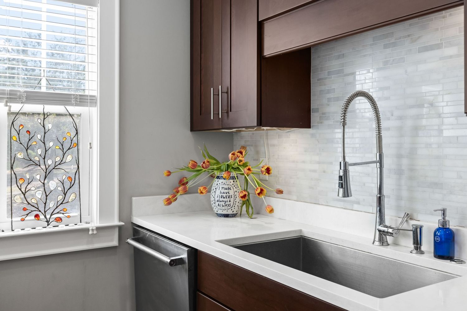 Kitchen sink with marble backsplash and natural light, detailed interior photo by Coast Captured Real Estate Photography 30A