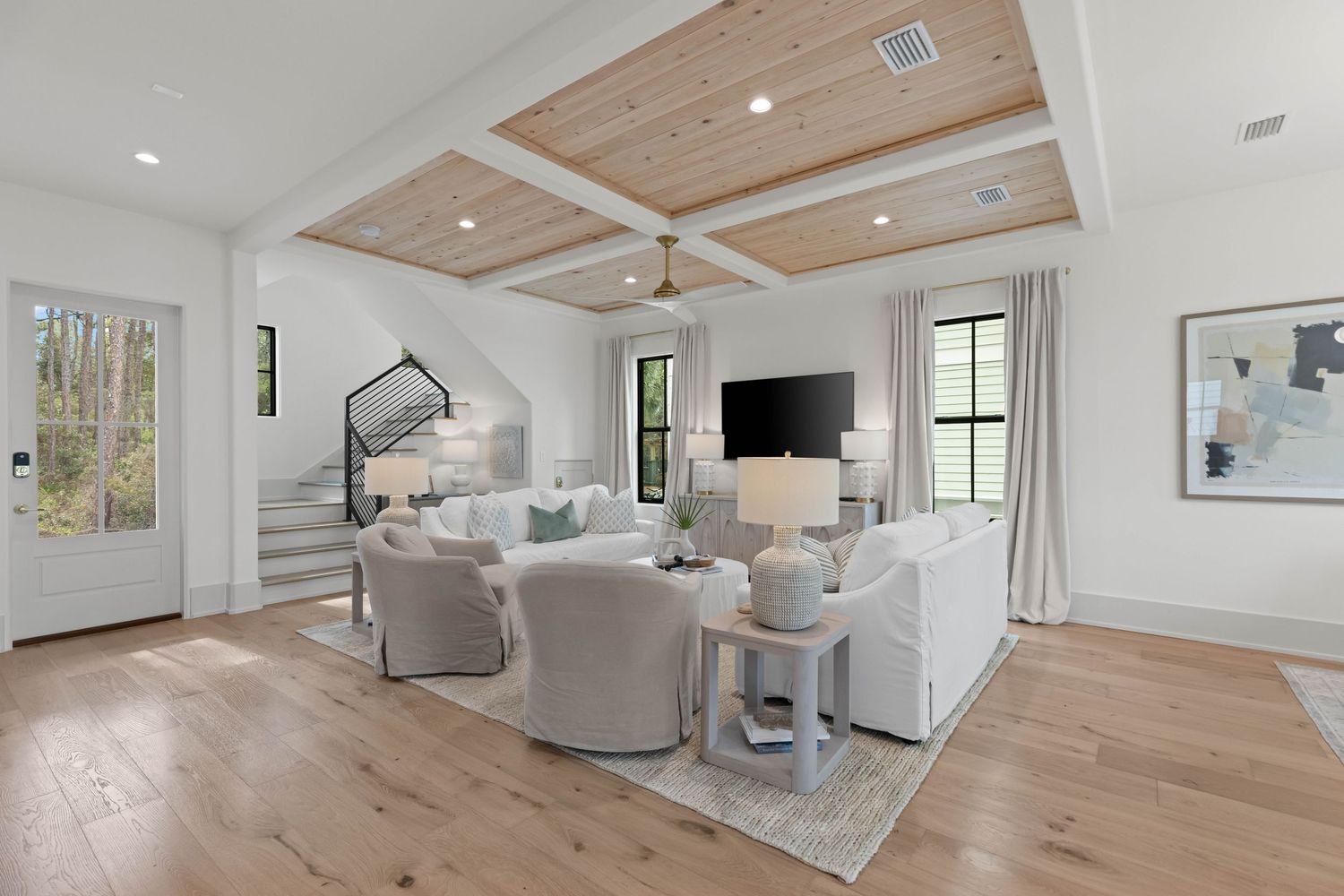 Open living and dining area with vaulted ceilings and neutral coastal design, photographed by Coast Captured for 30A real estate marketing