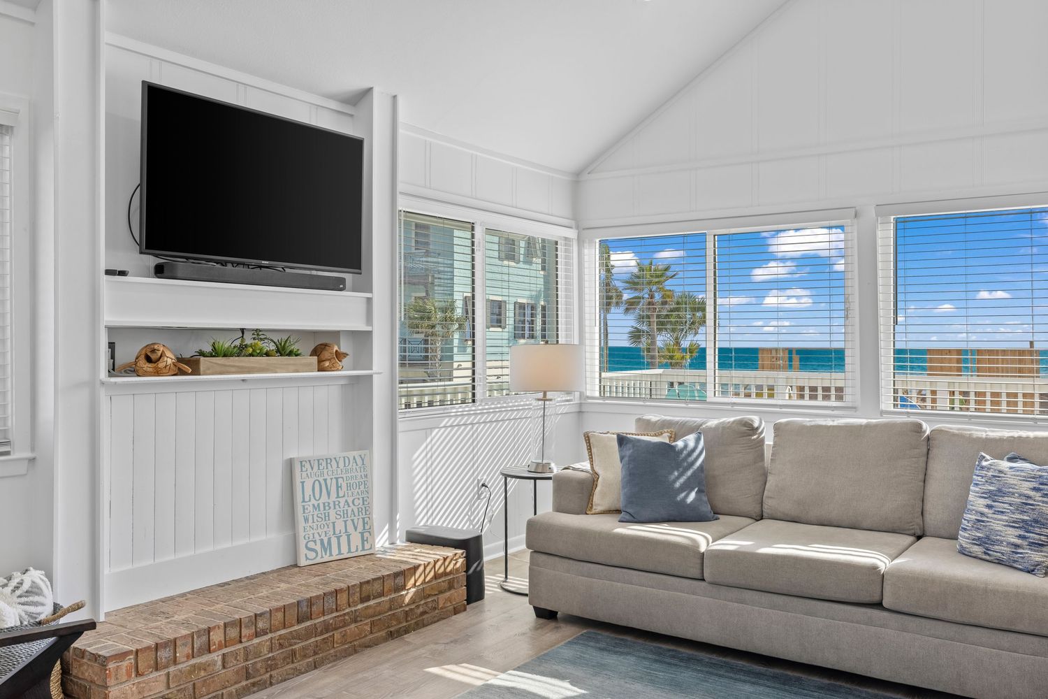 Coastal family room with large windows and ocean view, professional real estate interior photo by Coast Captured 30A Florida