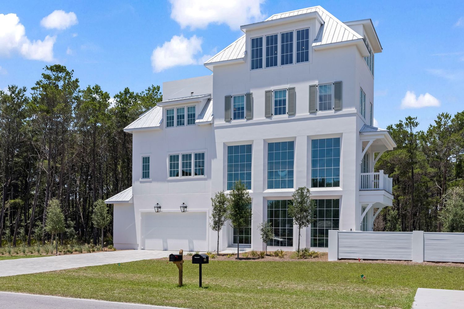 Modern white coastal home with three stories and large windows, 30A real estate listing photographed by Coast Captured Florida