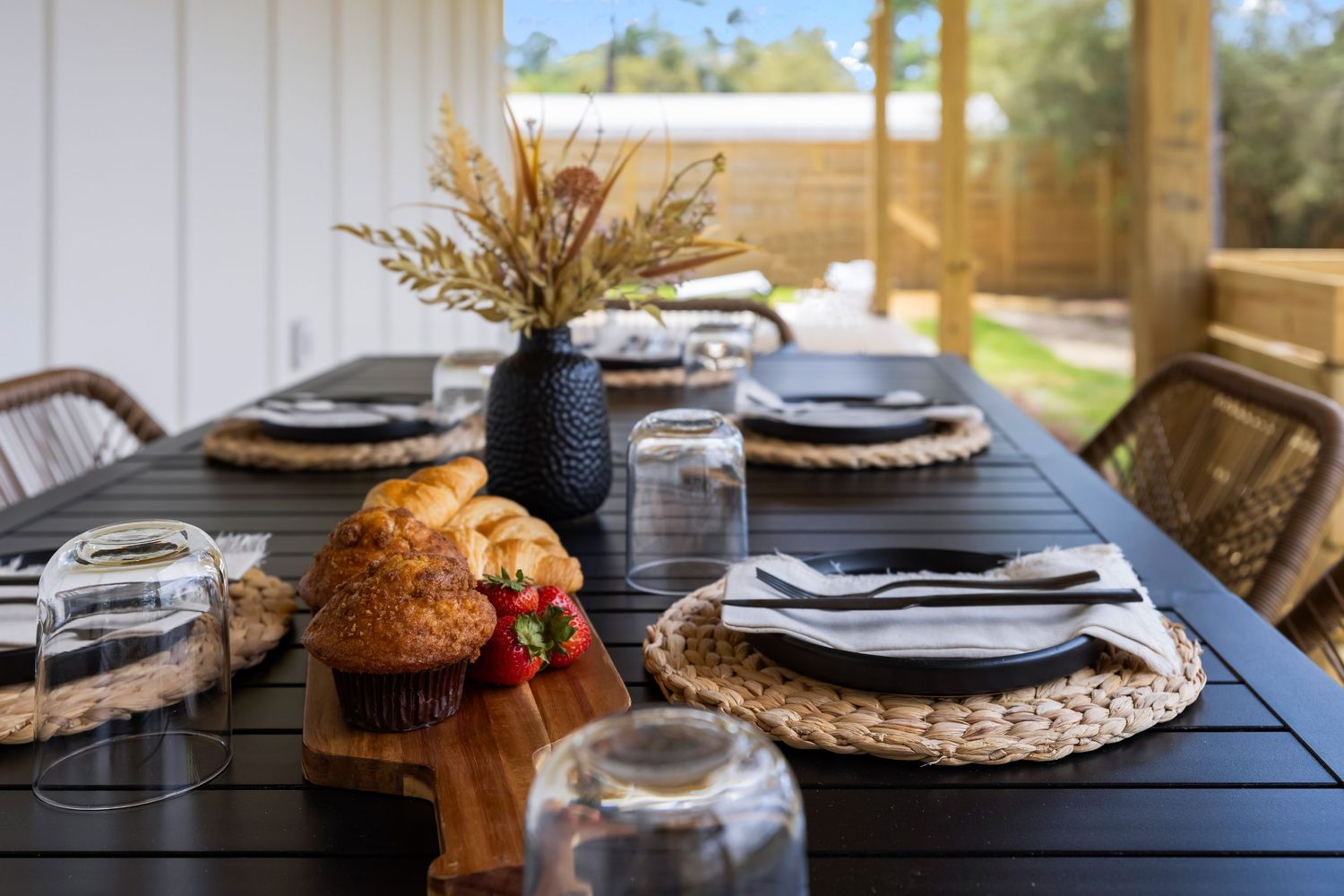Outdoor dining table set with decor and natural light, lifestyle photo by Coast Captured Real Estate Photography 30A Florida
