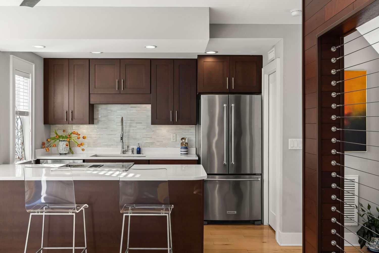 Modern kitchen with wood cabinetry and marble countertops, interior photo by Coast Captured for Emerald Coast real estate