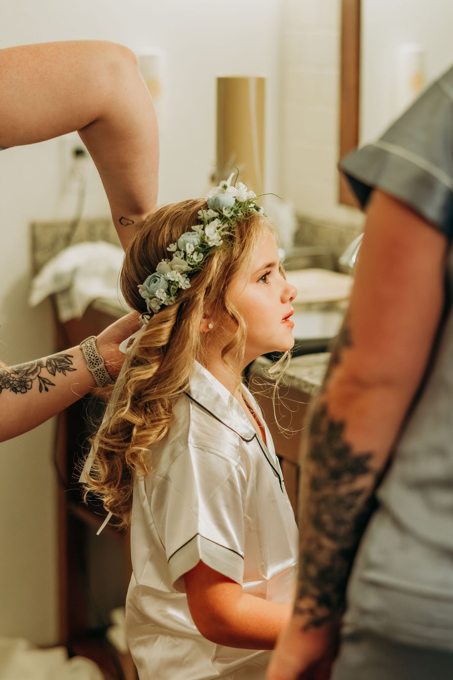 Young flower girl getting floral crown placed in her hair before wedding. Northwest Indiana wedding venues.
