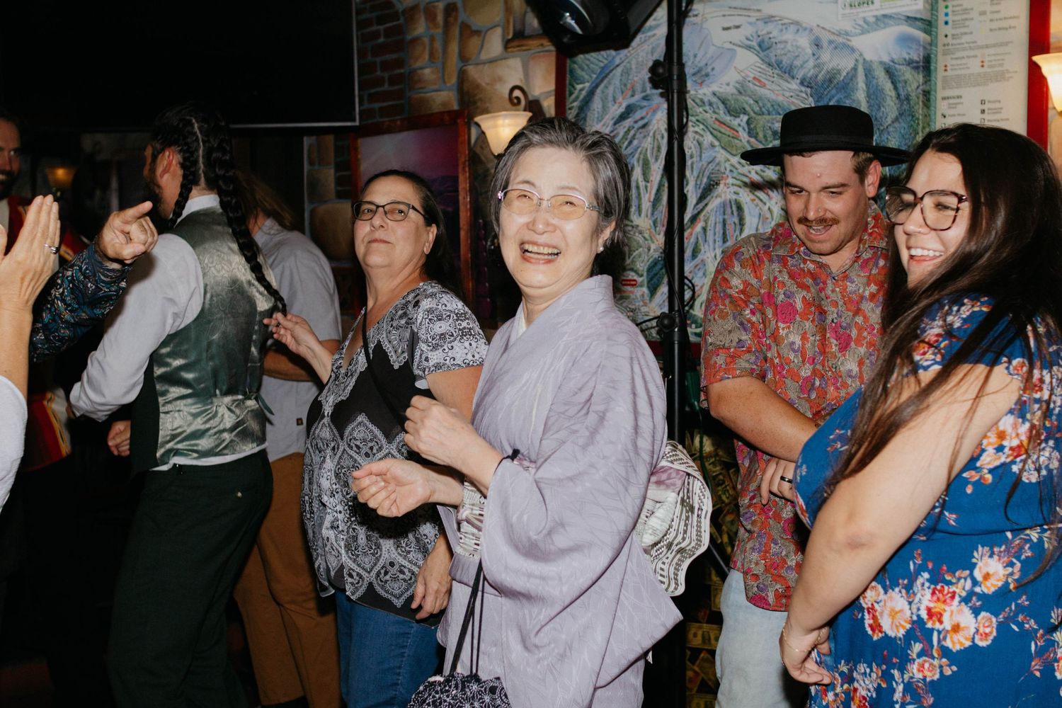 People dancing and socializing at a lively party or celebration event.