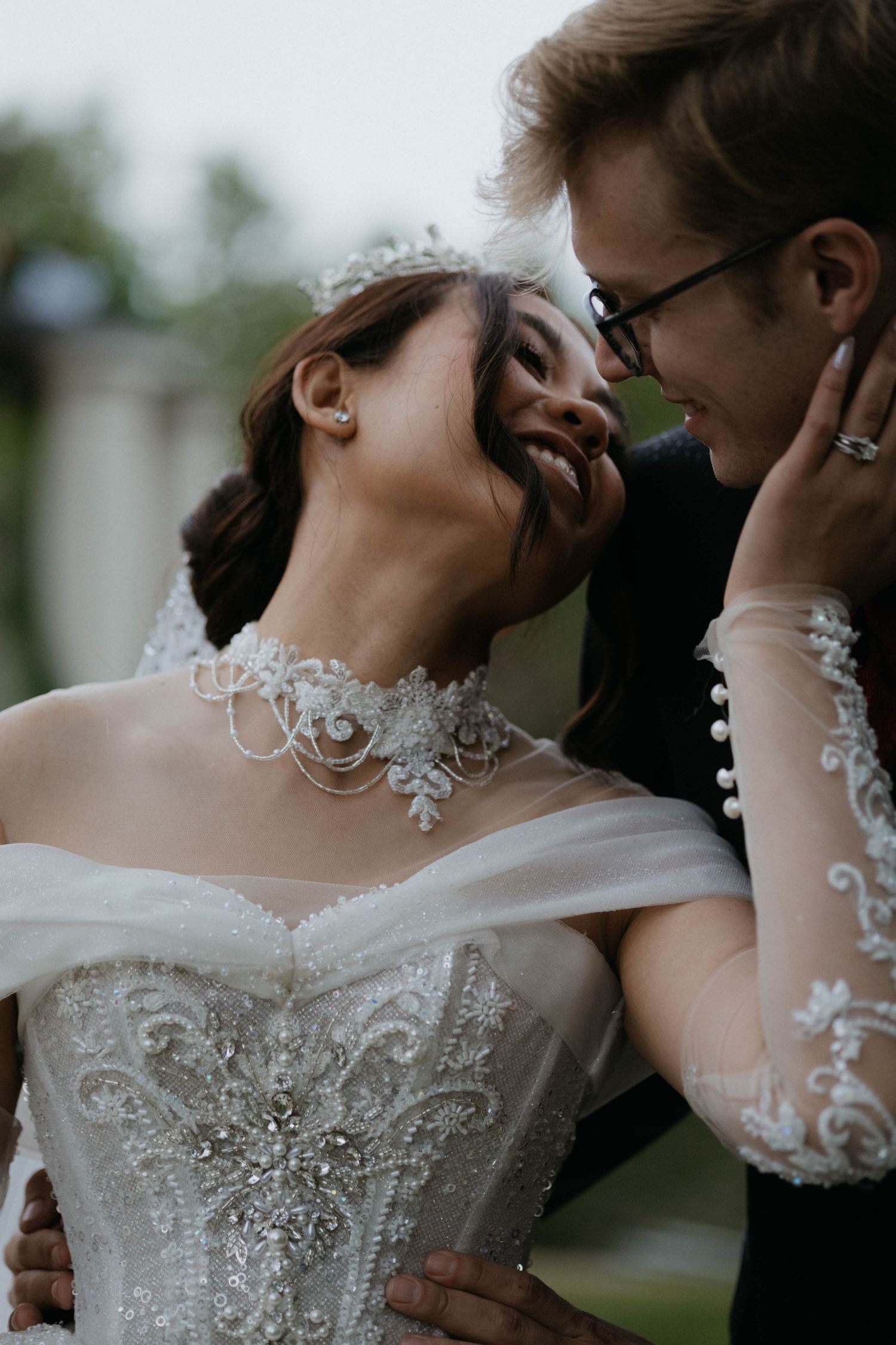 A romantic wedding couple shares an intimate moment in a series of close-up shots showing details of a lace bridal gown.