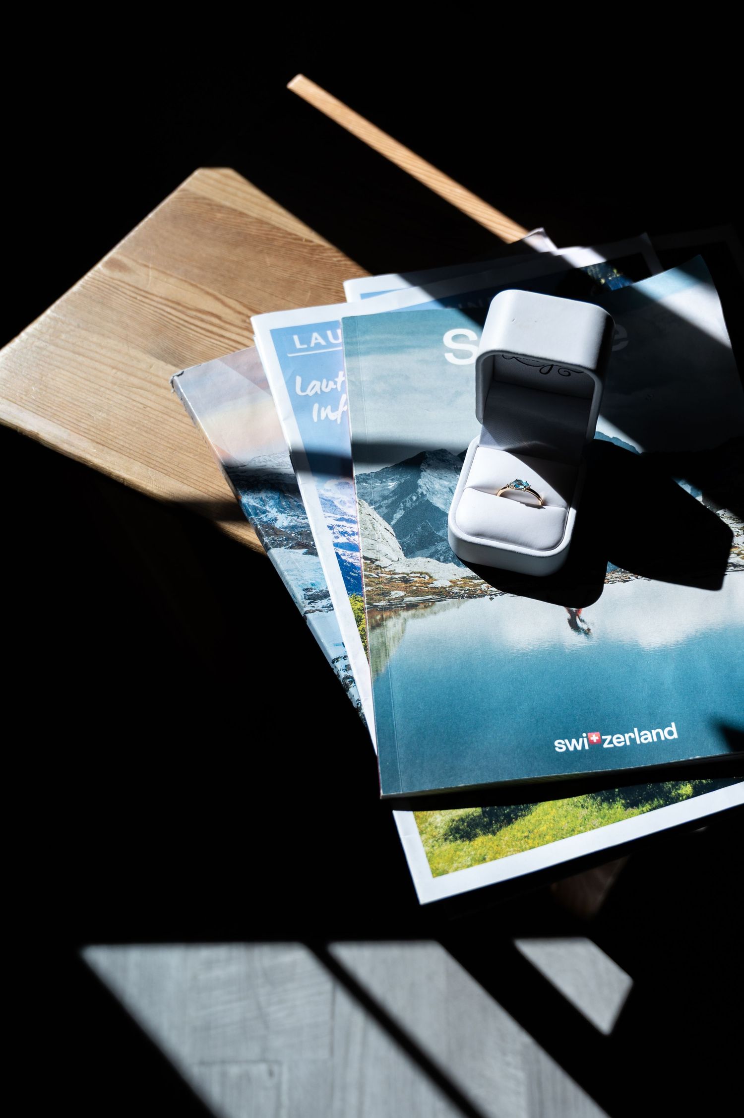 Wedding ring in white box displayed on Switzerland travel brochures and Lauterbrunnen tourism guides in Lauterbrunnen Switzerland.