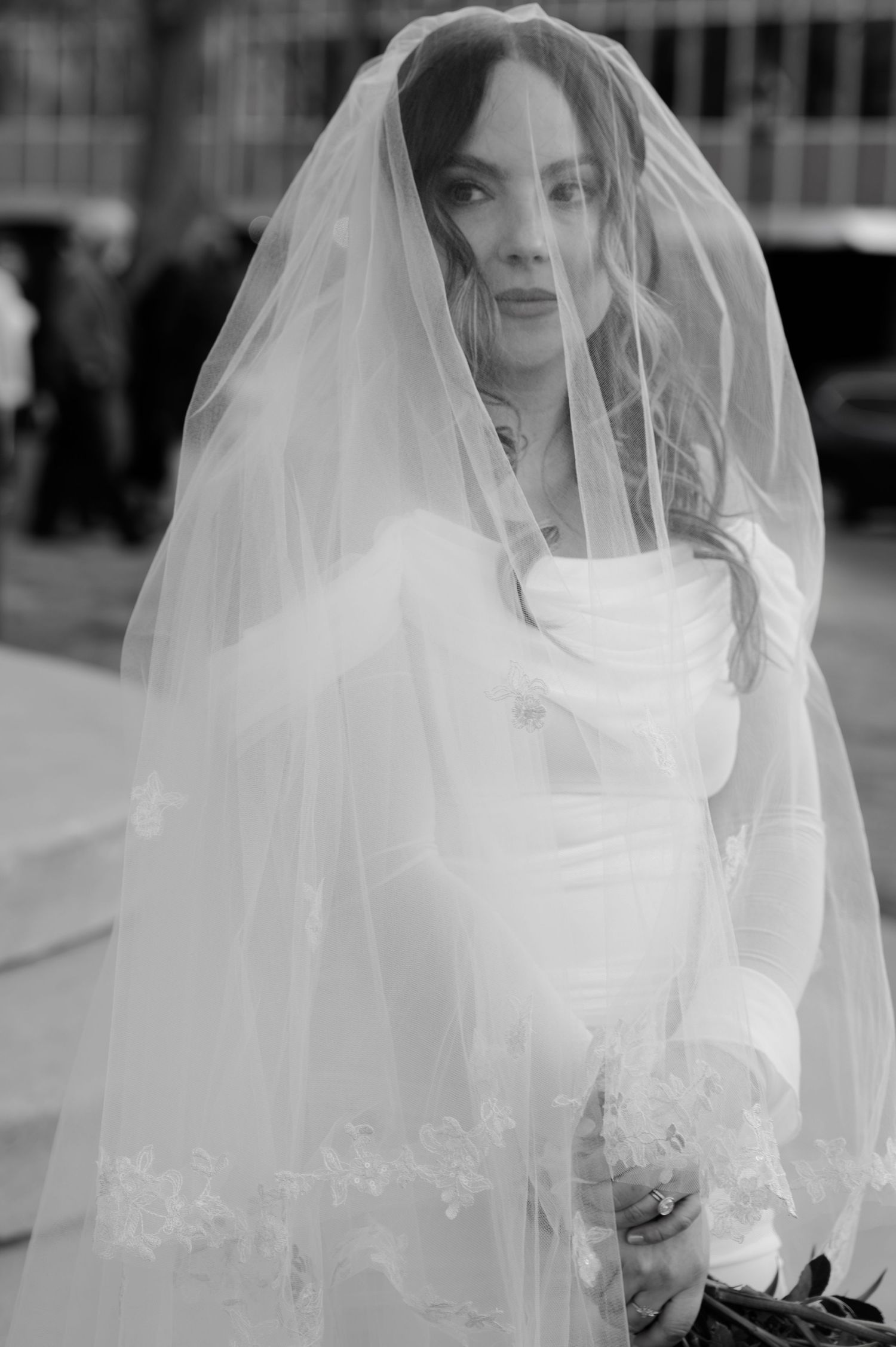 Elegant bride in white gown and lace veil in black and white wedding portrait at the Flagstaff courthouse in Arizona.