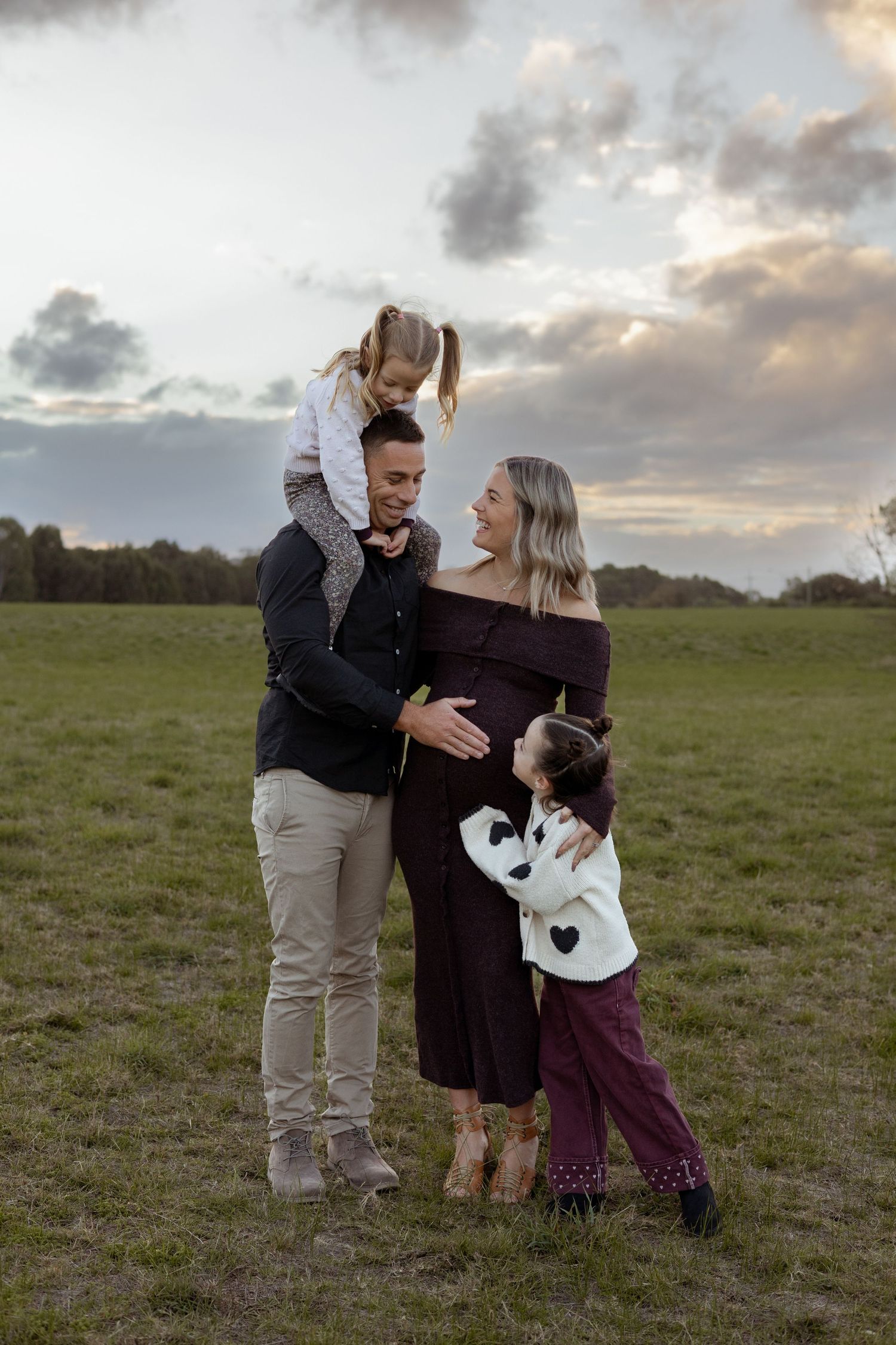 Family celebrating a new baby during a relaxed maternity photography session in Perth.