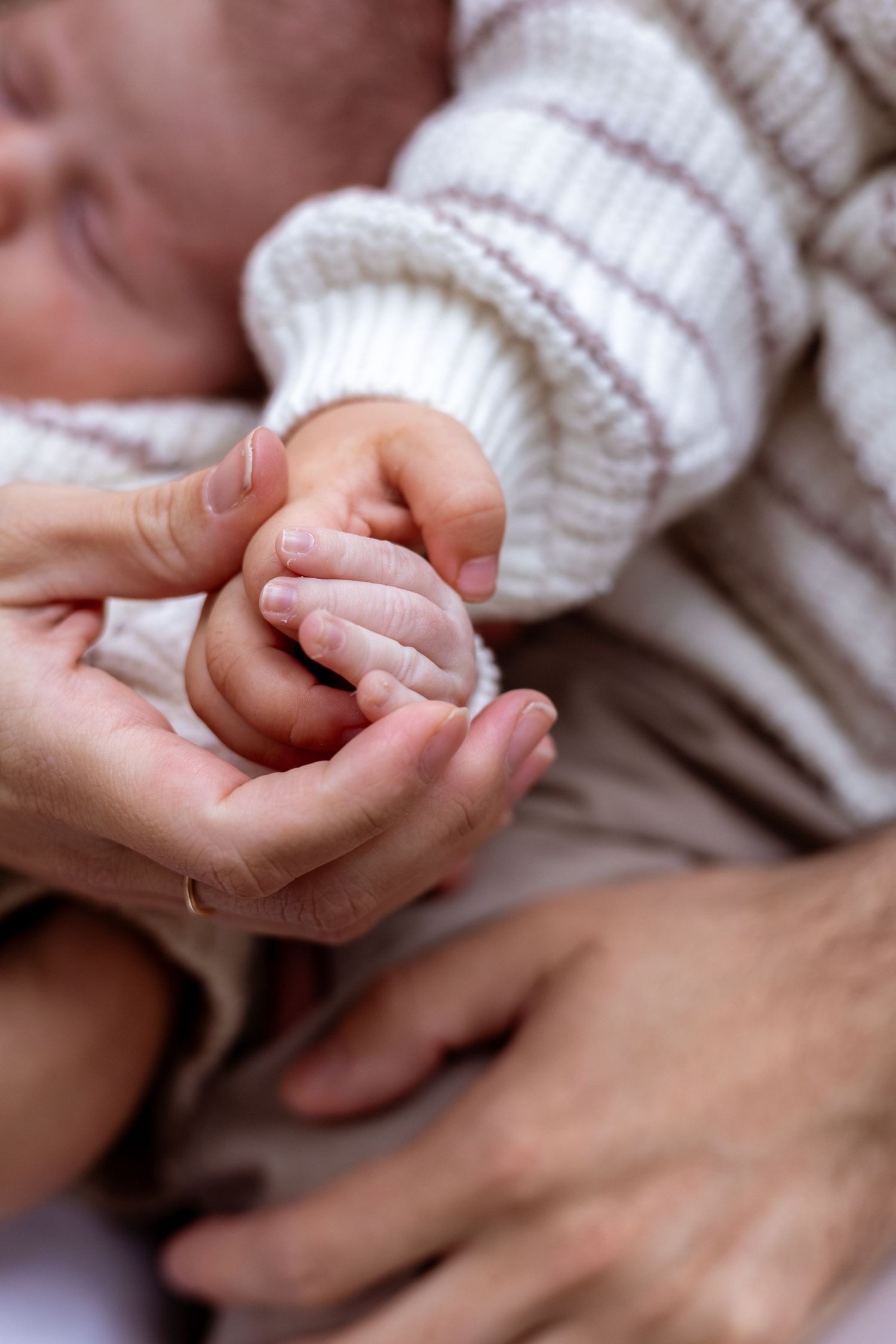 Perth family holding newborns hands