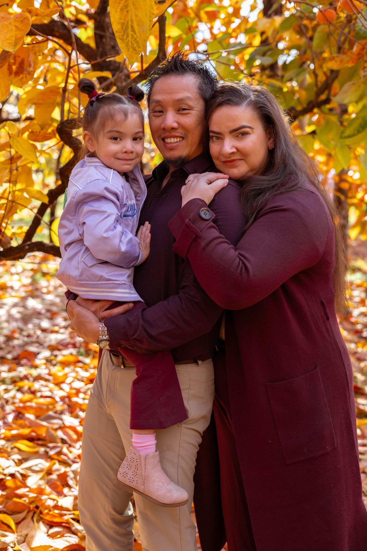 Parents cuddling their children during an outdoor family photography session in Perth.