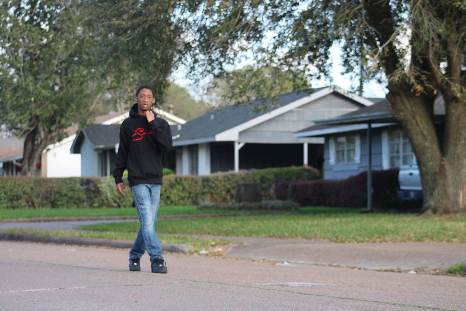 Portrait of a man walking outdoors in a residential neighborhood, photographed by ISHANIKA_PHOTOS_.