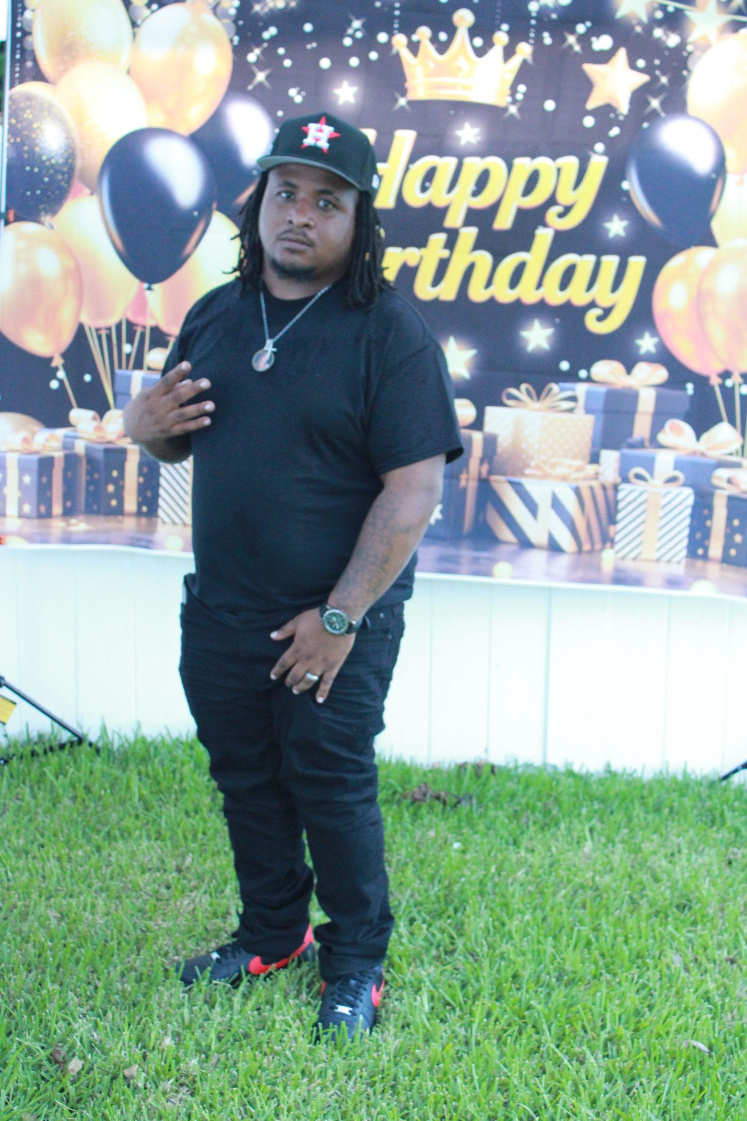 Birthday portrait of a client posing in front of a Happy Birthday backdrop, photographed by ISHANIKA_PHOTOS_.