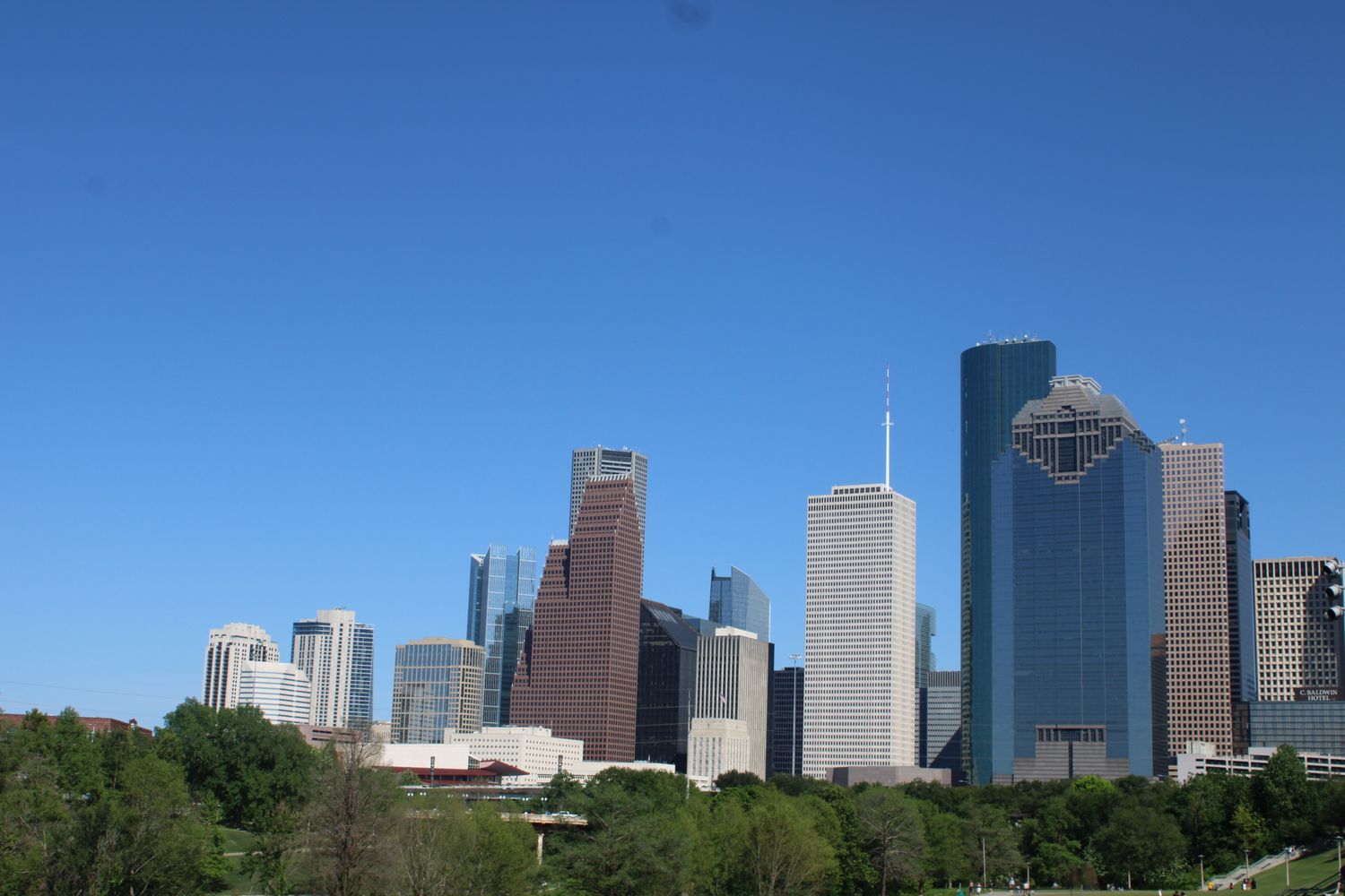 Houston Texas downtown skyline with modern skyscrapers under a clear blue sky.