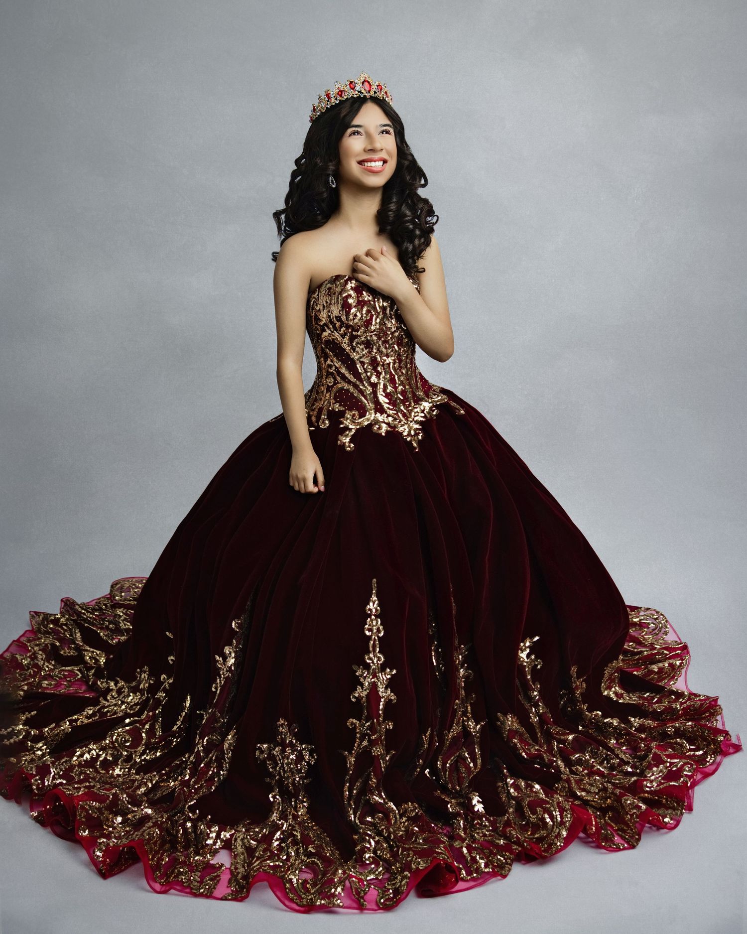 A luxurious burgundy quinceanera ball gown with gold embroidery and a full tulle skirt photographed in multiple poses.