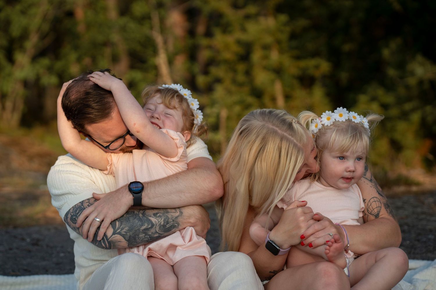 Family shares tender moments together in a series of outdoor portraits against a natural background.