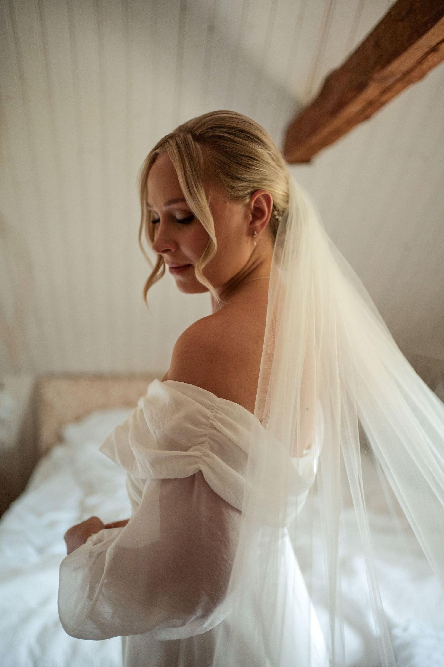 A bride in a white gown with flowing veil is photographed in a romantic sequence of ethereal poses.