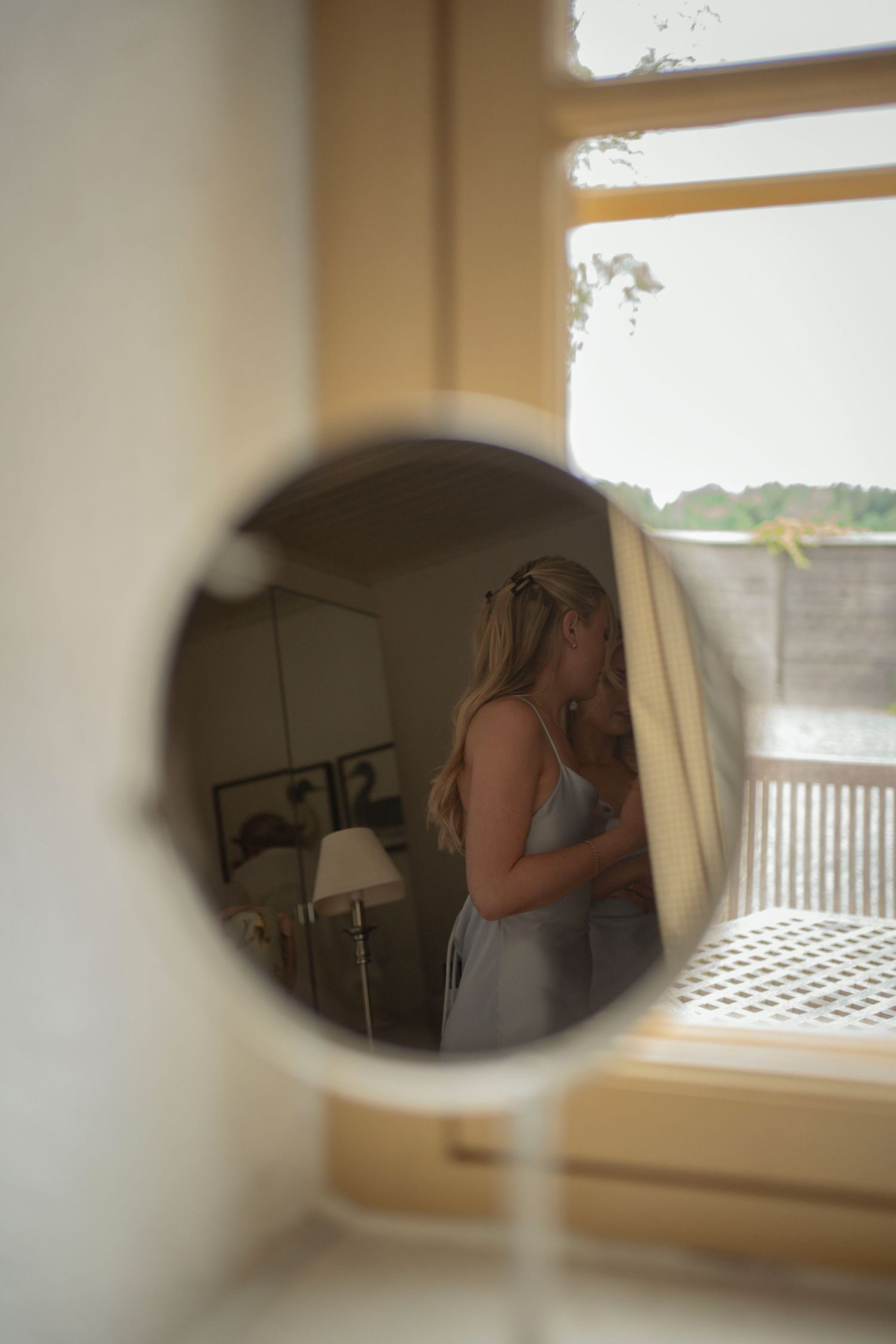 A series of blurred, dreamlike images captured through a peephole or small opening showing a soft-focus interior scene.