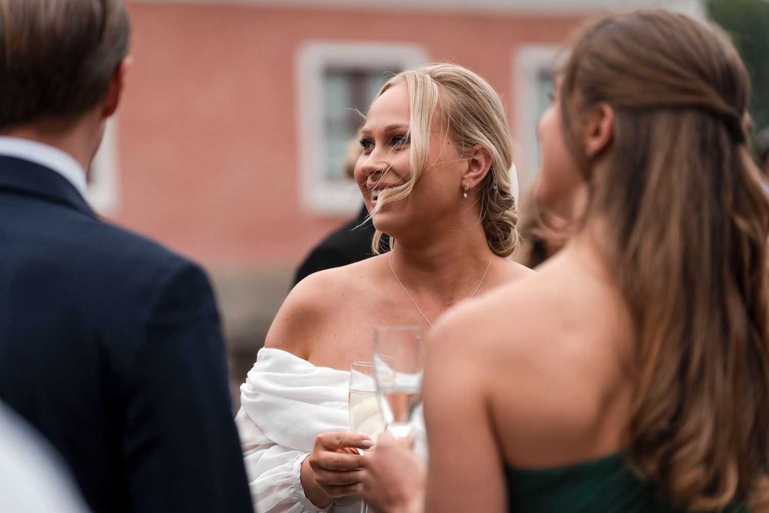 Wedding guests dance and celebrate together during an outdoor evening reception.