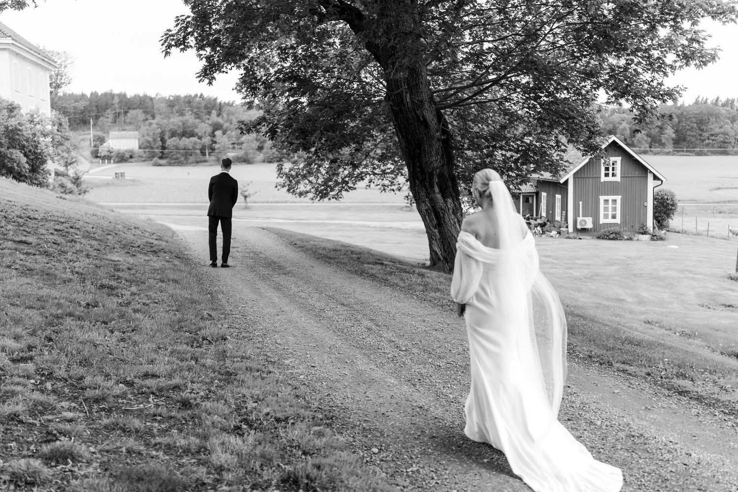 Black and white photo series showing a romantic countryside wedding photoshoot along a tree-lined rural road.