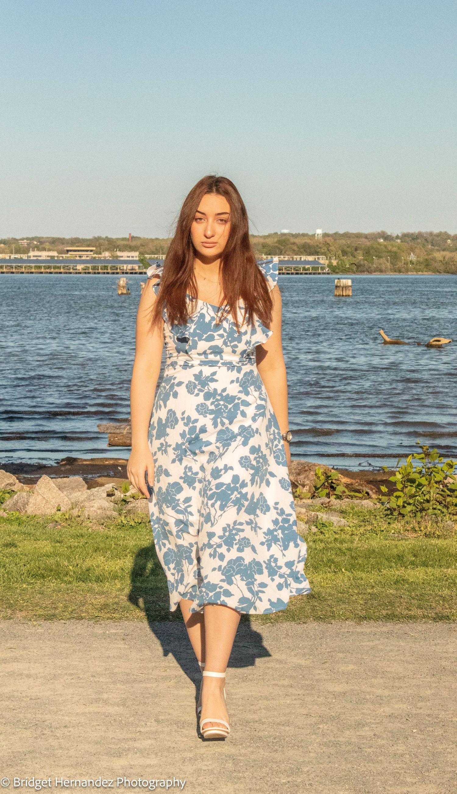 Series of photos by waterfront showing floral blue and white dress with scenic lake view.