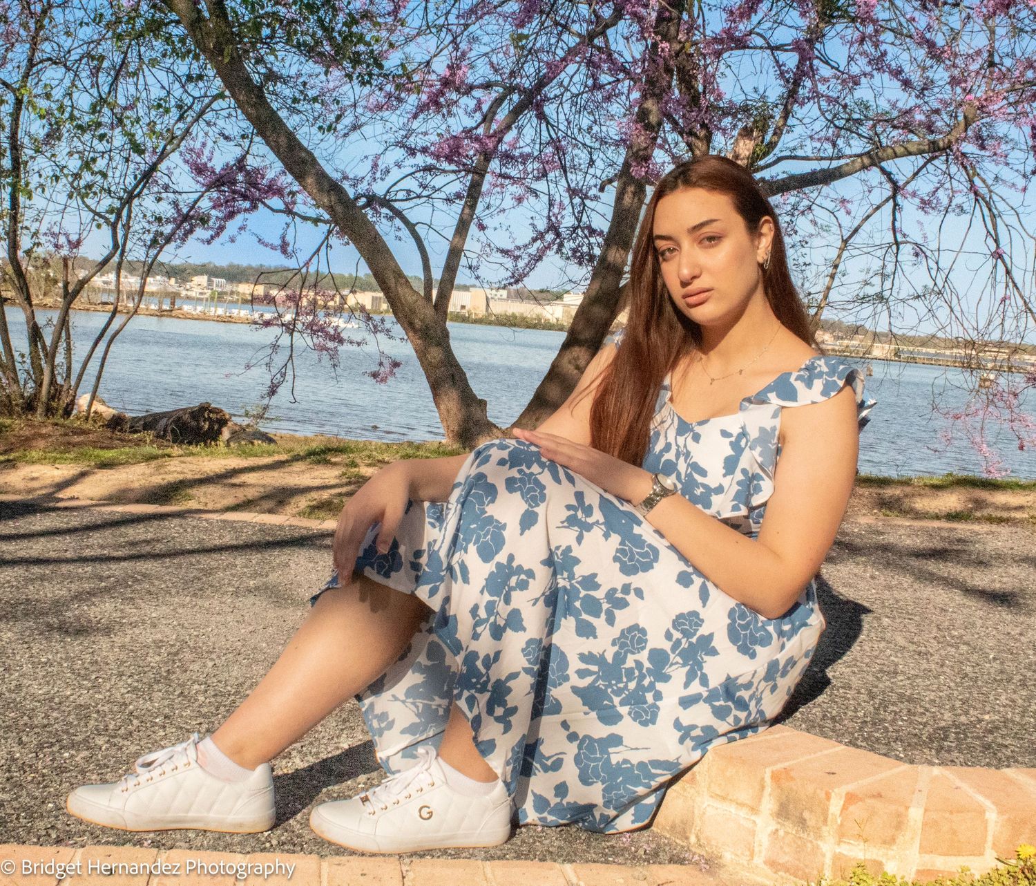A blue and white floral dress photographed during a spring day near water.