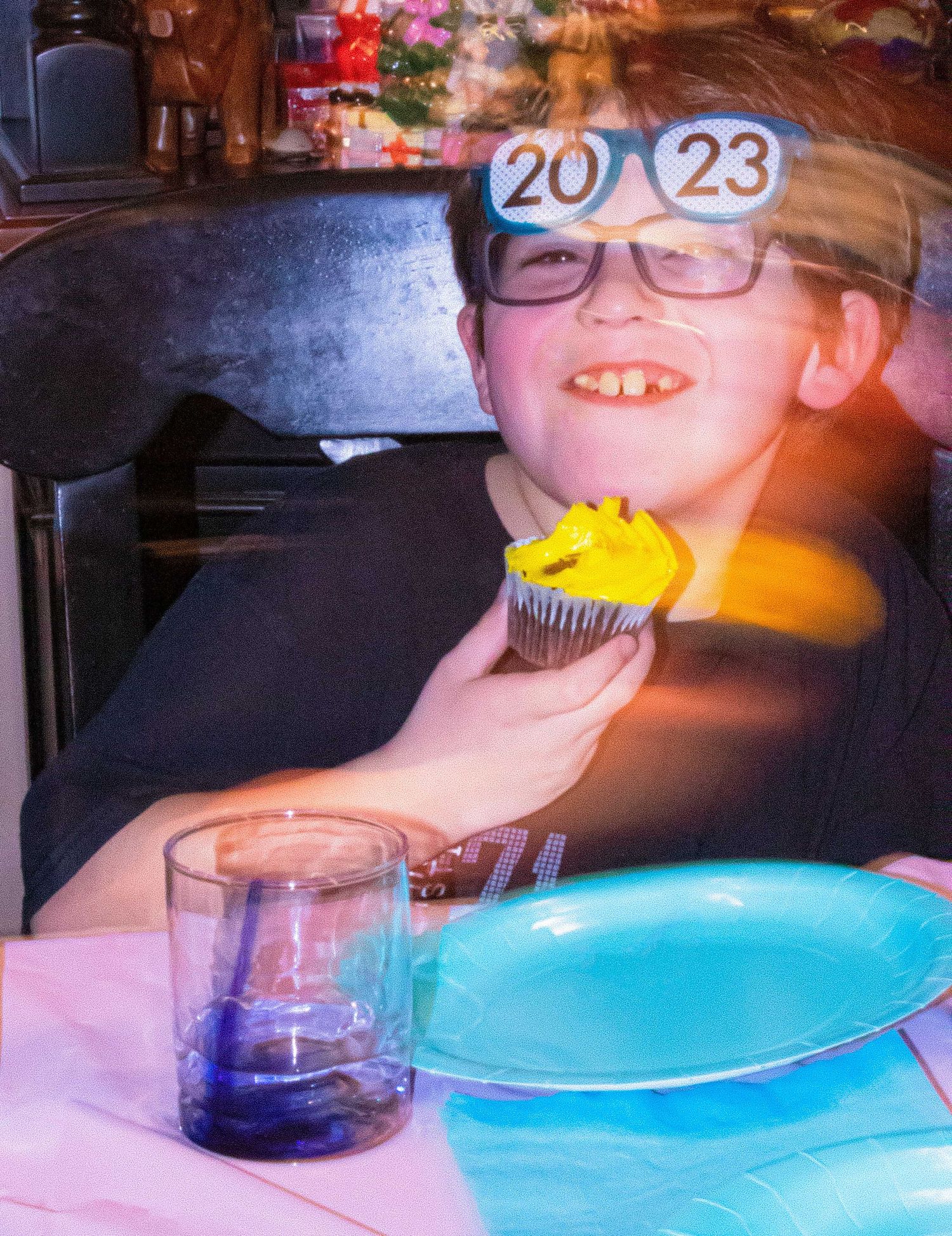 Birthday party scene with bright blue plates and festive lighting.