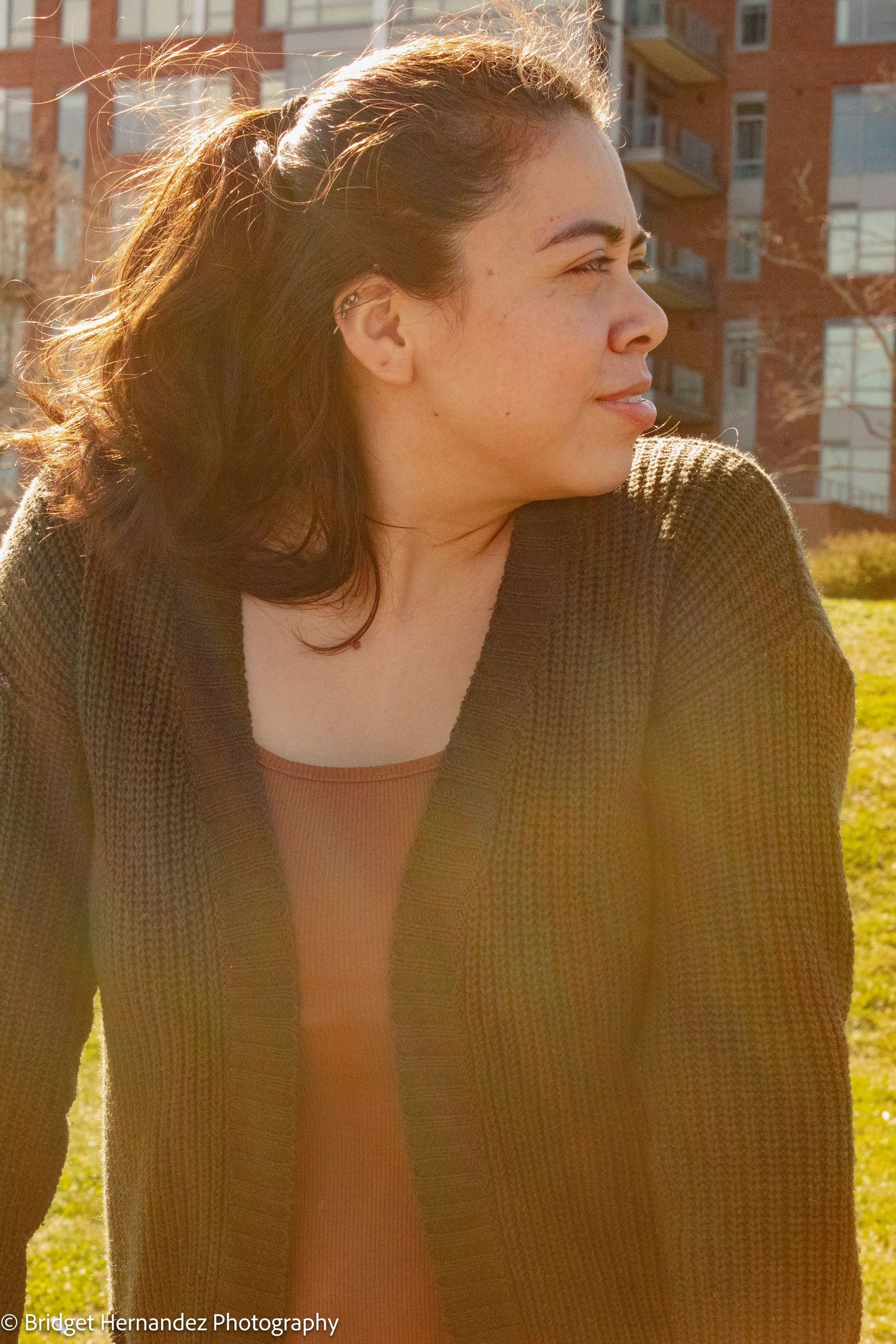 Sunset portraits with warm backlighting creating golden glow through brown knit sweater.