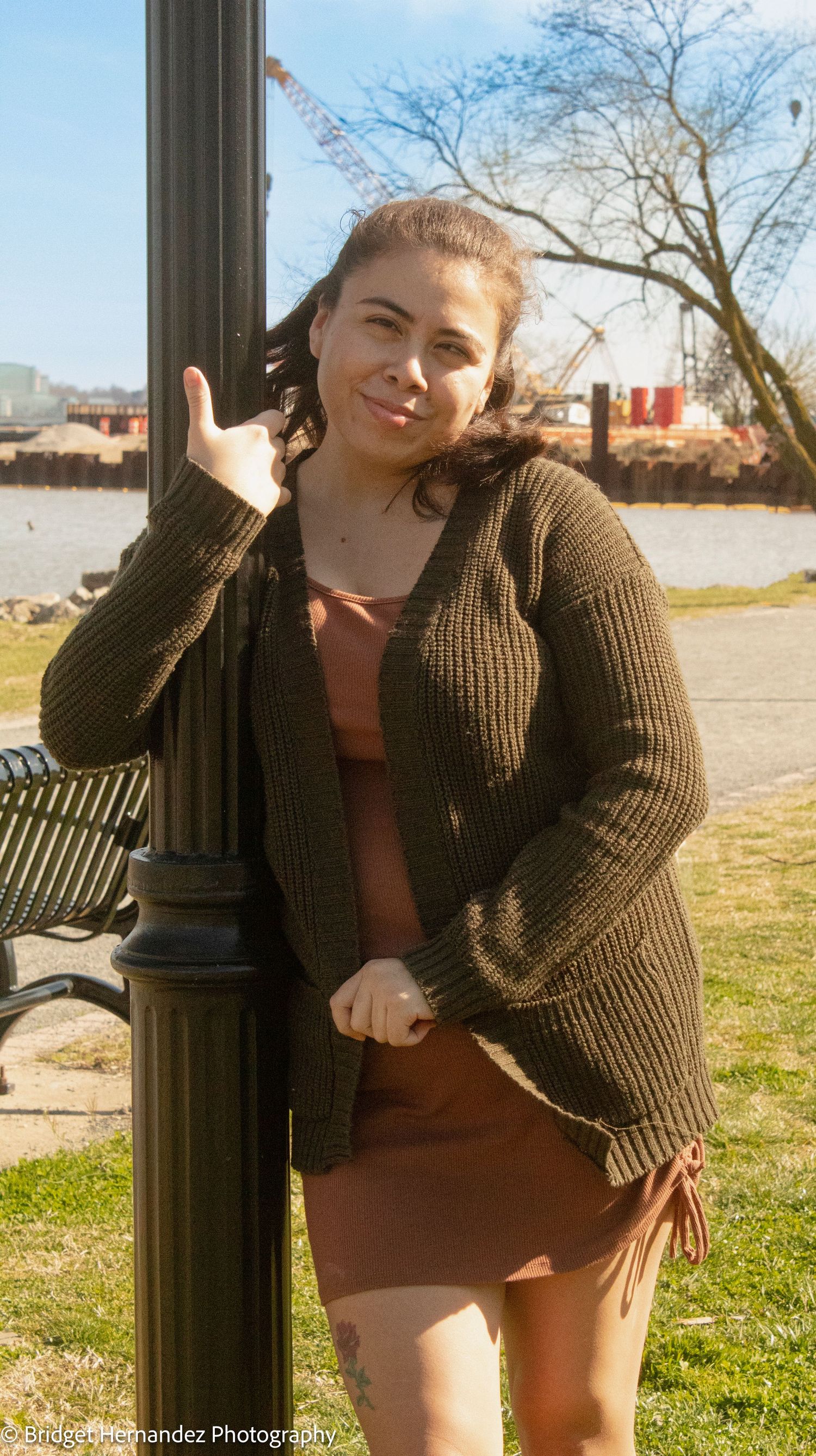 A photoshoot at sunset featuring poses near a black lamp post in a grassy area.