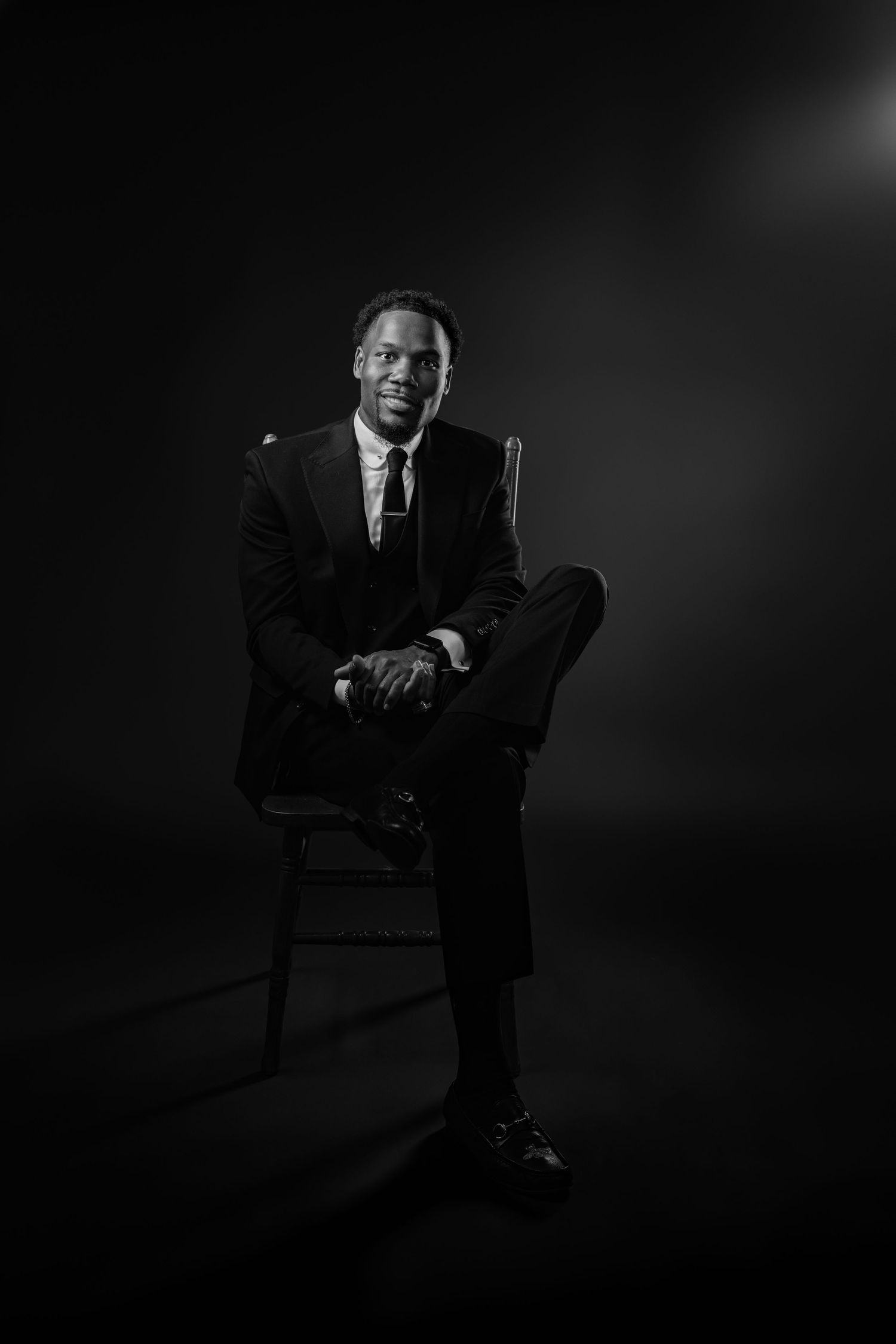 Dramatic black and white portrait series showing a person seated in a chair against a dark background.
