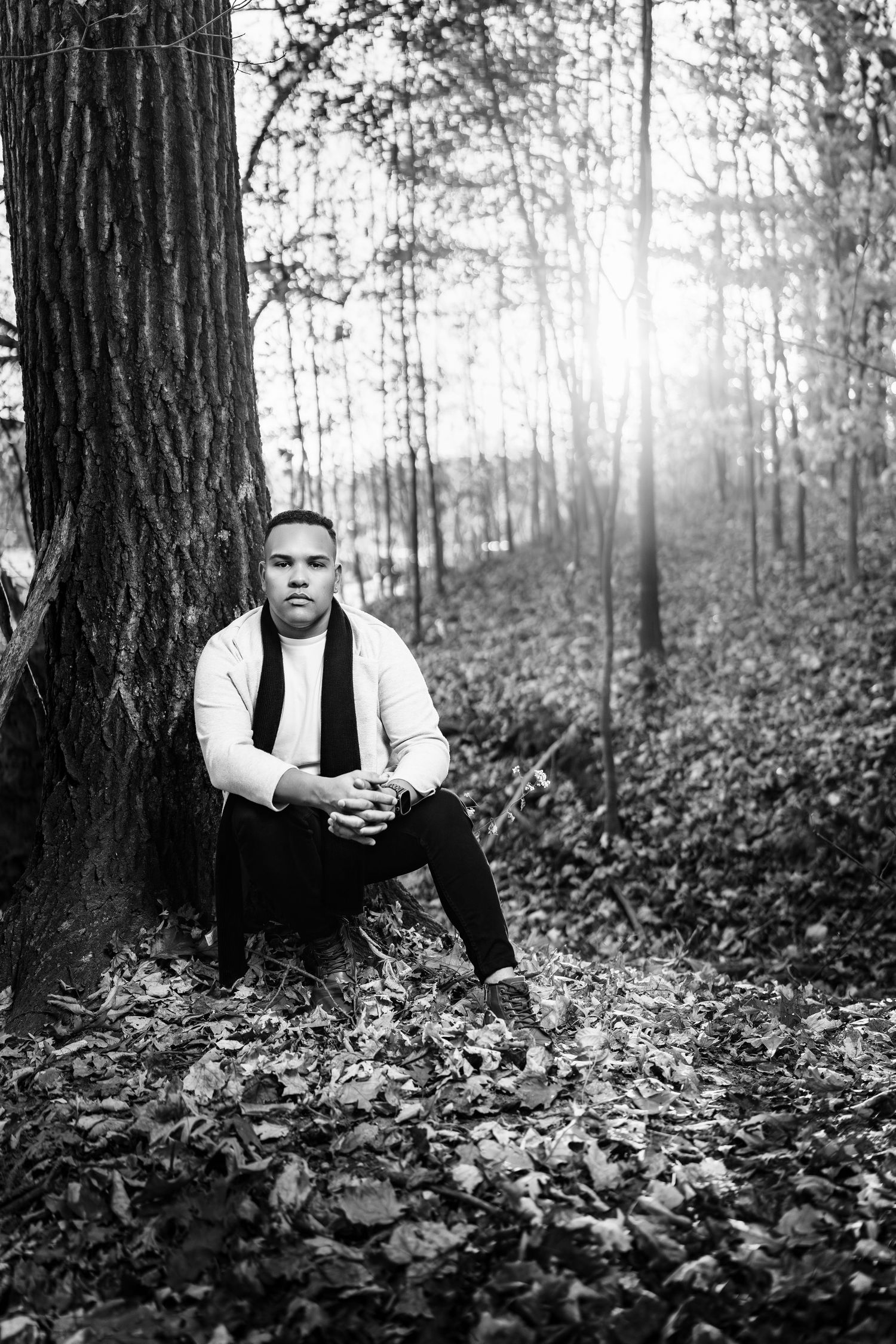Artistic black and white photo series showing a person peeking from behind trees in a misty forest setting.