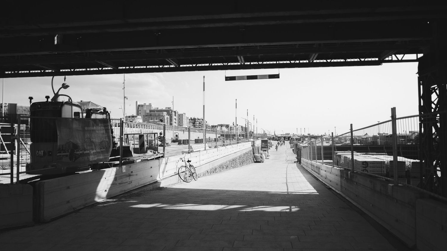 Four black and white panoramic views show a desolate street and industrial warehouses with bridges in an urban setting.