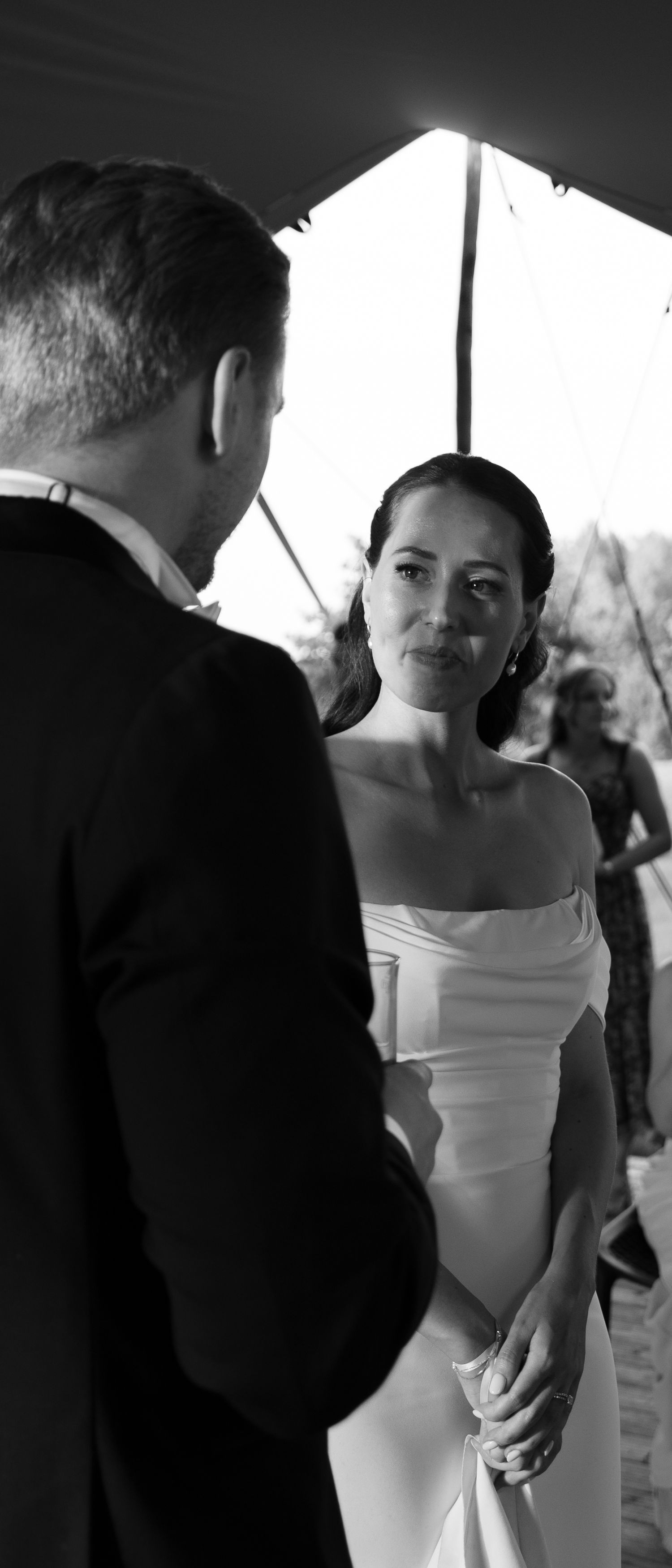 Black and white wedding ceremony photos showing intimate moments between a couple in formal attire.