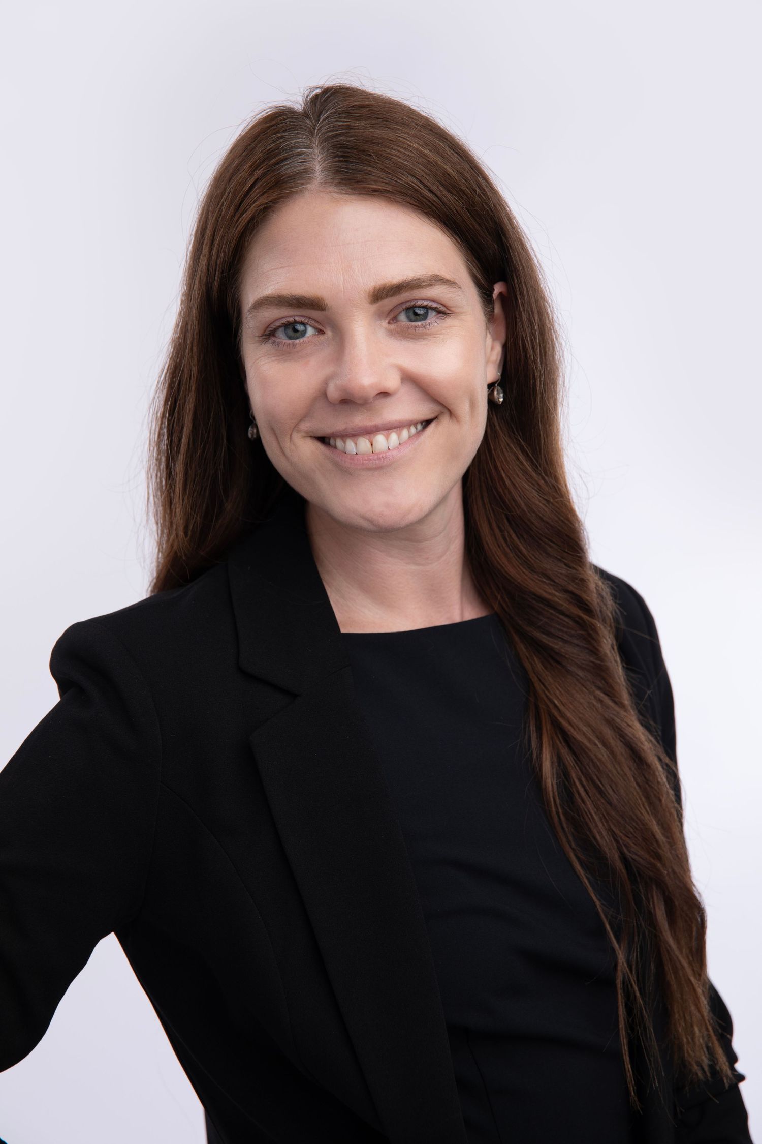 A professional portrait series showing different angles and expressions of a person with long dark hair wearing a black blazer.