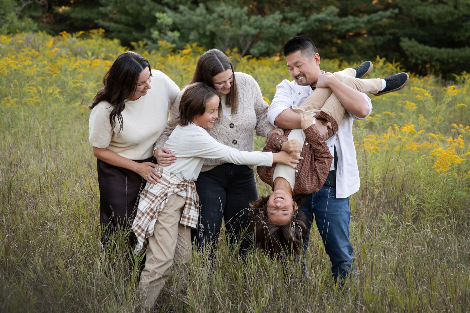 A joyful scene in a wildflower meadow with people playing and sharing laughter together in nature.