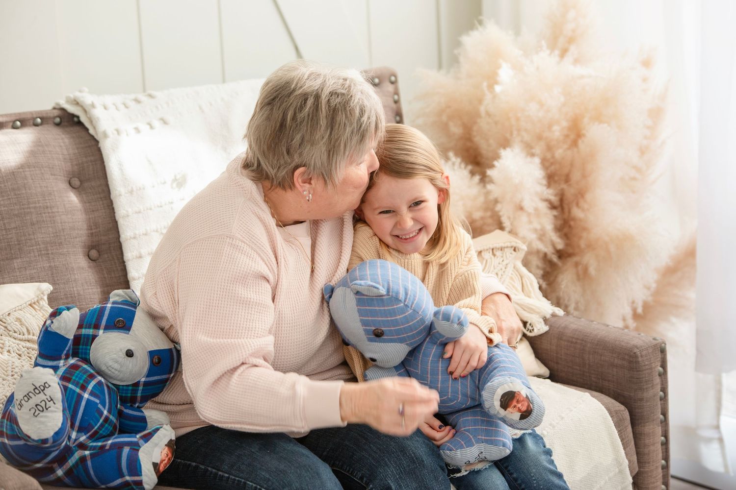 A tender family moment captured in a series of intimate lifestyle photos on a cozy couch in natural light.