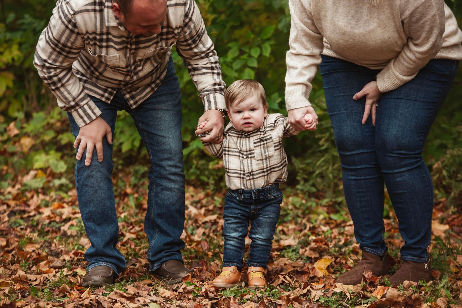 Series of casual family poses on fallen autumn leaves.