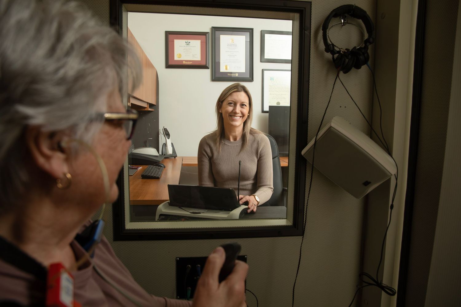 A person using video conferencing technology to connect with someone else remotely through a computer screen.