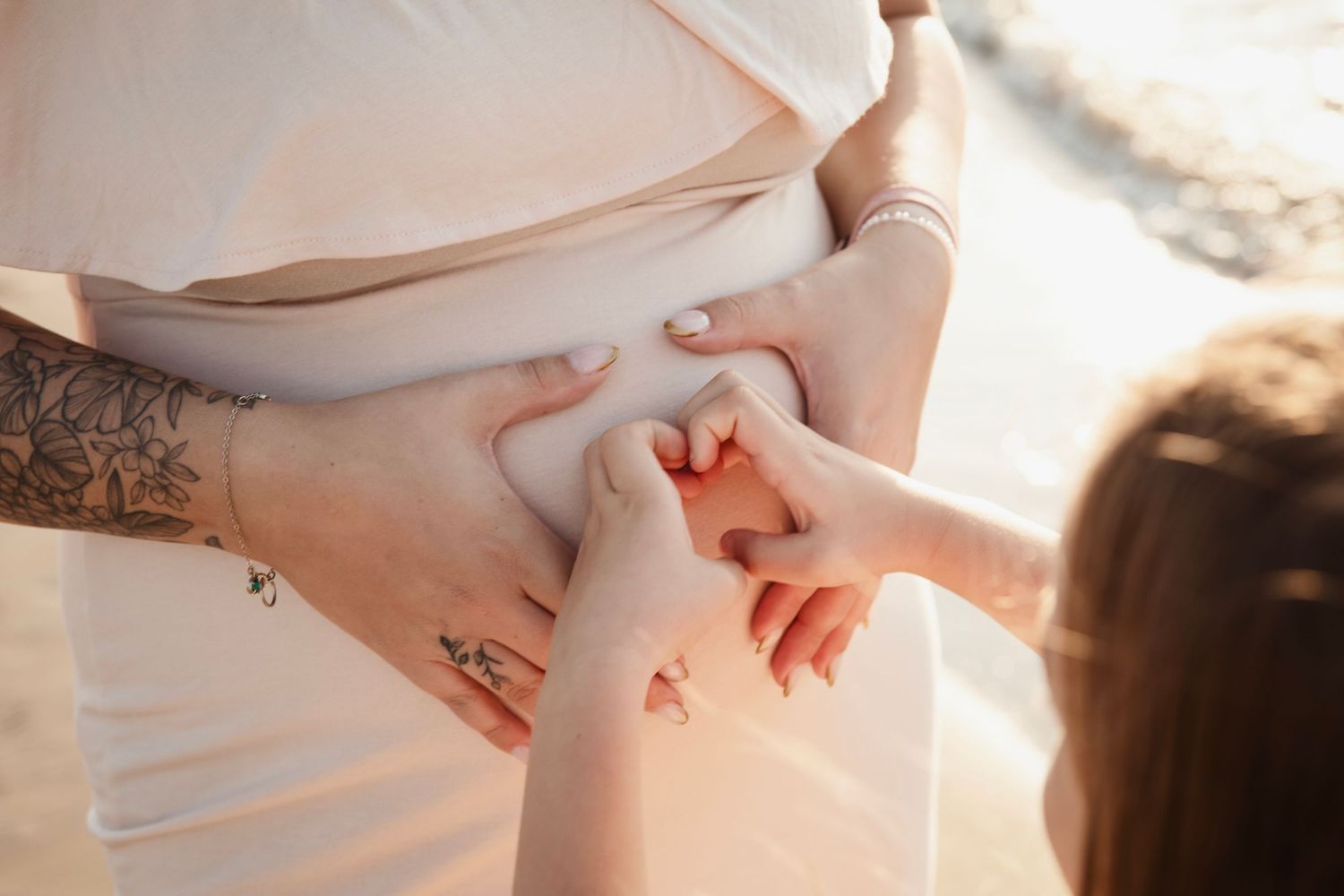 A hand reaches up and touches the small of the back to demonstrate a gentle massage technique or stretching motion.
