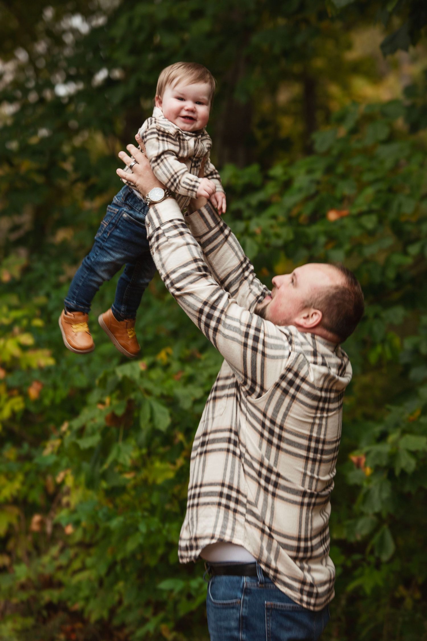 Playful moments captured in autumn forest setting.